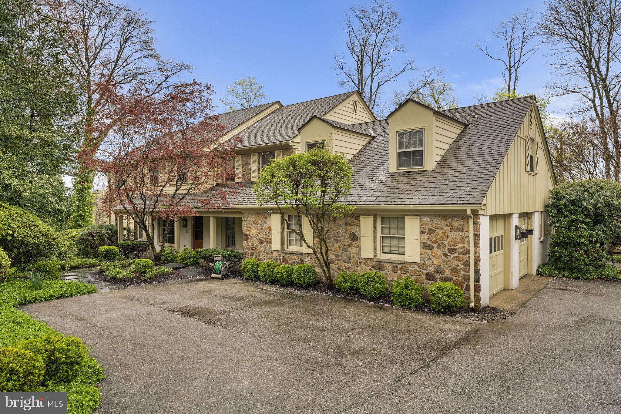 Park-like grounds and updated interiors create an inviting residence nestled on a beautiful cul-de-sac in Bryn Mawr. Inside the 4,600 square-foot residence the entry way introduces the living and entertaining spaces highlighting details that include hardwood floors, carpeting and millwork throughout with tremendous attention to detail. Upon entering the foyer, you are brought to the center of the home. The Dining Room has abundant natural light, two built ins and easy access to the Kitchen, Family Room, and Living Room. The formal Living Room has beautiful windows, sliding doors that access the back brick patio providing access to the rear yard. The stunning kitchen is a gourmand’s delight with crafted cabinets, quartz topped counters, working island with storage, and top of the line appliances including a Thermador range, double ovens, Bosch refrigerator, dishwasher, beverage refrigerator, and large sink. An adjacent sun-filled breakfast nook welcomes casual dining and has access to the back brick patio through sliding doors. Adjacent to the kitchen is a mud room with large closets, an office, full bathroom, and access to the two-car garage. The family room houses a wall of windows and sliding doors, hardwood floors, a striking stone, wood burning fireplace, perfect for cozy gatherings.
The second floor provides Five Bedrooms and Two full Baths. The Primary bedroom has beautiful windows and a new (2019) bathroom and walk in closet. The bathroom has double sinks, custom cabinetry, a large shower, and access to a private balcony with awning. The views from the balcony are breathtaking, highlighting the private back yard. The second Full bath was updated in 2022 and has double sinks, custom cabinetry, and a large tub/shower combination. There are two large linen closets and well as a third deep storage closet in the main hallway for ample storage. Each of the other bedrooms have large closets and hardwood floors (some under carpeting). The attic is accessed from the hallway and provides additional storage.
The walk out Lower-Level houses the laundry, large family room area, and other rooms that can be used for additional offices, exercise area, bedroom, or storage. The setting and yard set this home apart. The back yard is fully fenced and has a heated plaster in ground pool. There are multiple patios and entertaining areas that allow for any outside activity. This home has a new roof (10 yrs.), HVAC replaced in 2022, Hot Water heater in 2023 and a whole house Generator installed in 2020. The attention to detail and care is evident throughout the home creating unique settings for entertaining as well as the living spaces any family desires. The location is close to shopping, the airport, and schools. Numerous parks are close by - Ashbridge Park that has over 28 acres dedicated to playgrounds, running trails as well as tennis and sledding. Stoneleigh is up the street and features 42 acres available for exercise, picnics, and horticulture. The Harriton House and The Appleford Estate also add additional historical and recreational options. The combination of the private setting with the accessibility of these amenities creates a perfect balance for today's family.