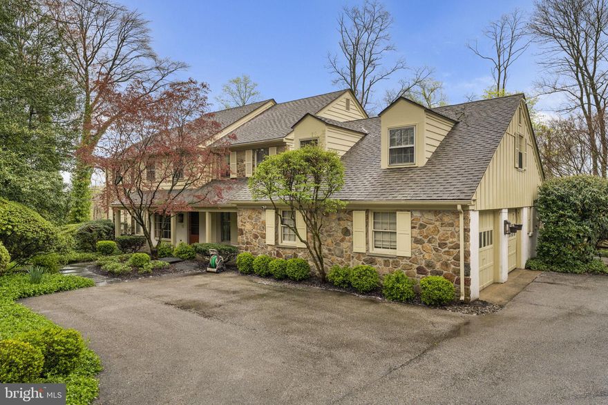 Park-like grounds and updated interiors create an inviting residence nestled on a beautiful cul-de-sac in Bryn Mawr. Inside the 4,600 square-foot residence the entry way introduces the living and entertaining spaces highlighting details that include hardwood floors, carpeting and millwork throughout with tremendous attention to detail. Upon entering the foyer, you are brought to the center of the home. The Dining Room has abundant natural light, two built ins and easy access to the Kitchen, Family Room, and Living Room.  The formal Living Room has beautiful windows, sliding doors that access the back brick patio providing access to the rear yard.  The stunning kitchen is a gourmand’s delight with crafted cabinets, quartz topped counters, working island with storage, and top of the line appliances including a Thermador range, double ovens, Bosch refrigerator, dishwasher, beverage refrigerator, and large sink. An adjacent sun-filled breakfast nook welcomes casual dining and has access to the back brick patio through sliding doors. Adjacent to the kitchen is a mud room with large closets, an office, full bathroom, and access to the two-car garage.  The family room houses a wall of windows and sliding doors, hardwood floors, a striking stone, wood burning fireplace, perfect for cozy gatherings. 
The second floor provides Five Bedrooms and Two full Baths.  The Primary bedroom has beautiful windows and a new (2019) bathroom and walk in closet.  The bathroom has double sinks, custom cabinetry, a large shower, and access to a private balcony with awning.  The views from the balcony are breathtaking, highlighting the private back yard.  The second Full bath was updated in 2022 and has double sinks, custom cabinetry, and a large tub/shower combination.  There are two large linen closets and well as a third deep storage closet in the main hallway for ample storage.  Each of the other bedrooms have large closets and hardwood floors (some under carpeting).  The attic is accessed from the hallway and provides additional storage.  
The walk out Lower-Level houses the laundry, large family room area, and other rooms that can be used for additional offices, exercise area, bedroom, or storage.  The setting and yard set this home apart.  The back yard is fully fenced and has a heated plaster in ground pool.  There are multiple patios and entertaining areas that allow for any outside activity. This home has a new roof (10 yrs.), HVAC replaced in 2022, Hot Water heater in 2023 and a whole house Generator installed in 2020.  The attention to detail and care is evident throughout the home creating unique settings for entertaining as well as the living spaces any family desires. The location is close to shopping, the airport, and schools. Numerous parks are close by - Ashbridge Park that has over 28 acres dedicated to playgrounds, running trails as well as tennis and sledding. Stoneleigh is up the street and features 42 acres available for exercise, picnics, and horticulture. The Harriton House and The Appleford Estate also add additional historical and recreational options. The combination of the private setting with the accessibility of these amenities creates a perfect balance for today's family.