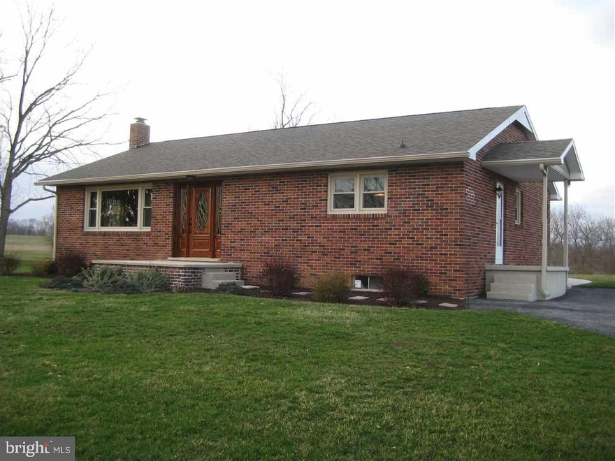 Beautiful brick rancher with views of the countryside on almost 1 acre! Everything has been remodeled with gorgeous details! New windows, roof, kitchen and bath, doors, flooring, list goes on!  Original hardwood floor in Living Room has been shined to perfection! HW floors under new carpeting in bedrooms as well. Tile look laminate in kitchen! Room to add garage!