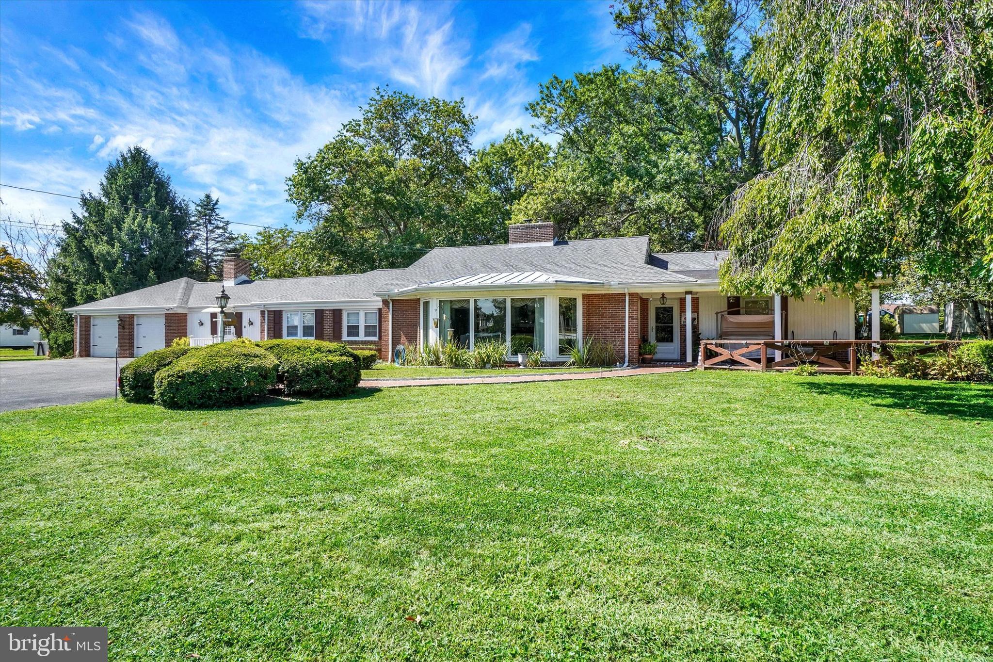 This lovingly maintained 3 bed, 2.5 bath Rancher on 1.43 acres offers over 2700 finished sq.ft. of gracious living space and many major updates for your comfort and peace of mind, including new roof, newer windows, and more! A large patio welcomes visitors into the main entry foyer, which leads of a huge living room with new bay windows and fireplace with wood burning insert, updated custom Kitchen with granite counters, exposed beams, prep island, built-in oven and cook-top range, and formal dining room with a wall of windows overlooking the backyard entertaining areas. Down the hall, two bedrooms, a full bath and first floor family room with gas/wood fireplace and separate front entrance provide comfort and flexibility for family or guests. The primary suite with dressing room and full bath is privately situated on the opposite side of the home. Downstairs, the partly finished basement includes a large game room or den, plus ample storage. An oversized two-car attached garage completes the home. Outside, the broad, level lot is shaded and secluded by mature trees in the backyard, and enhanced with a second patio, big gazebo, fire pit area and workshop with overhead door, creating a perfect space to enjoy sunny day fun, hobbies and gatherings. Located just outside of Stewartstown borough, you are just minutes to local dining, shops, schools, and parks, Shrewsbury shopping centers and I-83. This lovely home has something for everyone on your list. Schedule your showing today!