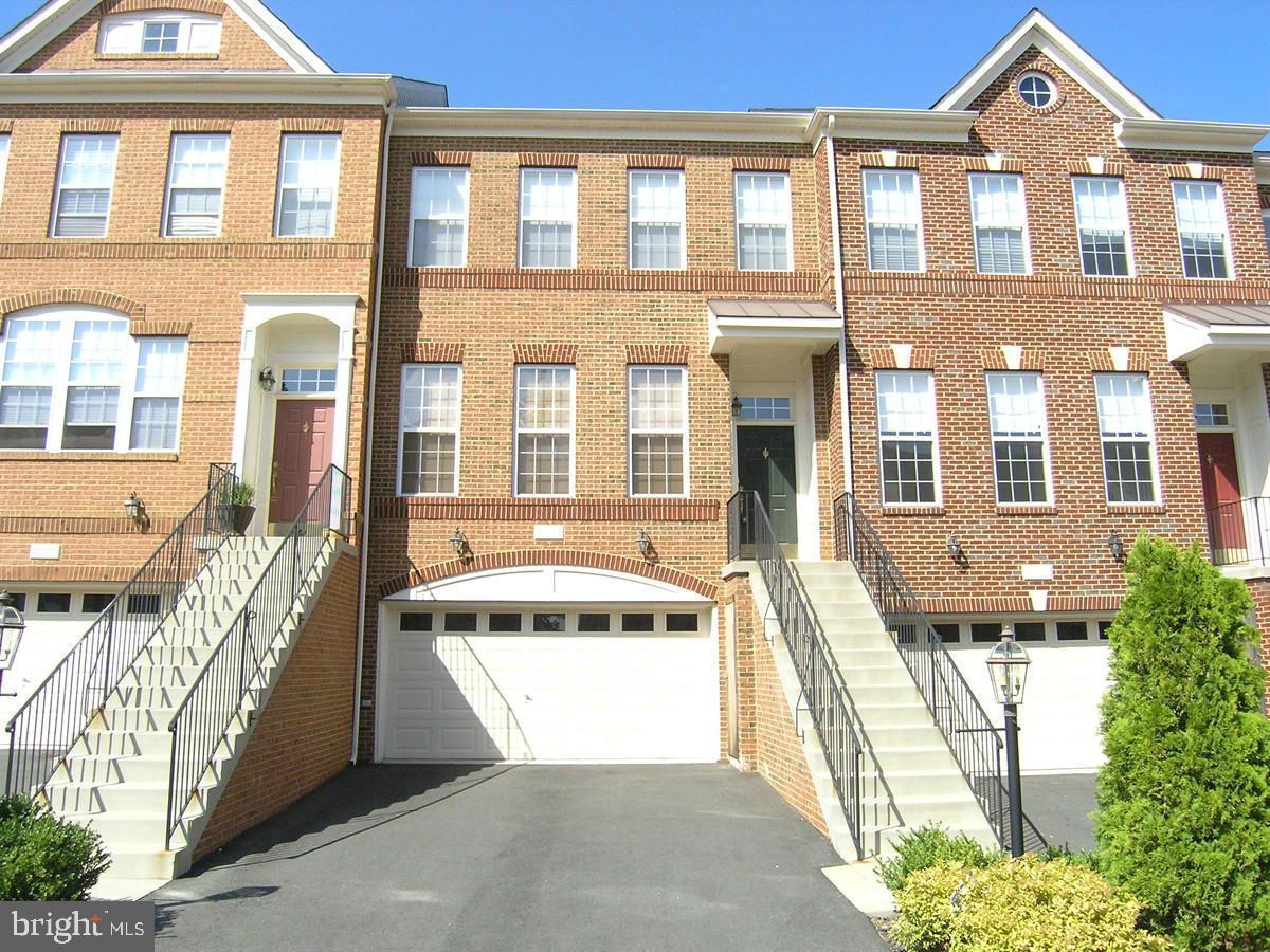 Stunning townhome, featuring 3 bedrooms, 3 full baths, and 1 half bath, complete with a 2-car garage. Located in the highly desirable Stone Ridge North community, this home offers a blend of elegance and comfort. Step inside to find hardwood floors throughout an open floor plan, with a family room and dining room filled with natural light. The rear gourmet kitchen is perfect for culinary enthusiasts and is ideal for entertaining. The upper level boasts a spacious primary bedroom with a private bath, along with two additional well-sized bedrooms. The lower level provides extra living space, a convenient full bath, and a walk-out to a patio fenced in back yard, perfect for relaxation. Fireplace & Ice maker As-Is