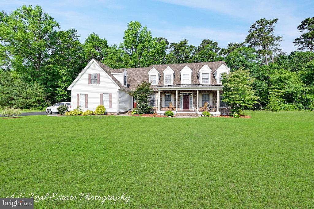 Welcome to your dream home, a timeless Cape Cod masterpiece offering 3700 ft.² of refined living perfectly cited on 2.71 serene acres at the end of a private cul-de-sac off of Wicomico County’s prestigious Riverside Drive. Move-in ready and exquisitely maintained, this 5BR, 3.5 BA home offers a semi-open floor plan that seamlessly blends formal living and dining rooms with casual elegance—perfect for both everyday living and upscale entertaining.
At the heart of the home is a beautifully updated kitchen with refinished cabinetry, granite countertops, stainless steel appliances, a new dishwasher, and a convenient, oversized adjacent laundry area featuring a brand-new washer and dryer (with 5-year warranty). The inviting den with fireplace, formal living room, and kitchen each open to a spacious screened-in patio—creating a seamless flow for indoor-outdoor living. The first-floor owner’s suite complete with a jacuzzi tub, tiled walk in shower and spacious his/her walk-in closet also enjoys direct access to this serene outdoor space, offering a quiet retreat morning or evening.
The hardwood staircase off of the 2-story foyer leads to the 4 additional generous BR, 2 full BA and an oversized flex space/bonus room ideal for a game/recreation area with a separate staircase leading to the kitchen area.
Recent updates include: Full geothermal system repair and maintenance, refinished kitchen cabinets, new bladder tanks, new washer/dryer, dishwasher, new hot water heater, new black aluminum fencing, extensive tree removal for improved views and safety, encapsulated crawlspace for enhanced energy efficiency and newly sealed driveway. (Totaling over $30,000, receipts will be provided upon request) Septic, termite, and home inspections were completed last week and will also be provided upon request.
Outside, enjoy the perfect mix of cleared yard and wooded privacy, with plenty of space for outdoor entertaining, recreation, or simply soaking in the peaceful setting. An exceptional blend of classic elegance, thoughtful updates, and modern ease—this is luxury country living at its best. Don’t miss this rare opportunity to own this exceptional property in a desirable, private location – where peace, comfort, and convenience come together. Schedule your private tour today!