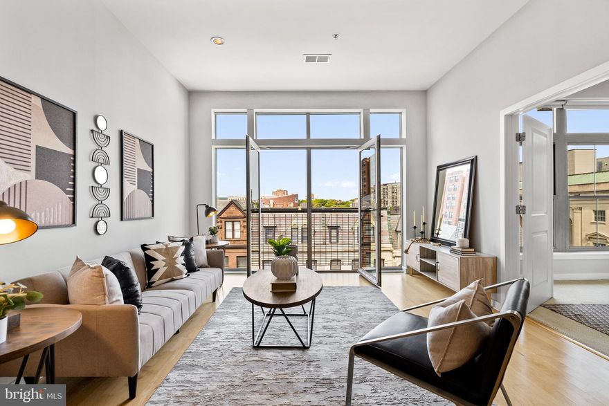 Welcome to this rare two-level penthouse unit located at 1209 N Charles St #415 in Midtown. The spacious 2 bed 2 bath home spans nearly 1,800 sqft, offering a grand scale living experience that is unrivaled. As you enter the first floor of the unit, you are greeted by high ceilings, hardwood floors, and an expansive open floor plan for the kitchen, living, and dining area. The floor-to-ceiling West-facing windows beautifully fill the space with natural light, creating a warm and inviting atmosphere. The kitchen features stainless steel appliances and granite countertops. The very spacious primary bedroom boasts a large California walk-in closet and an ensuite bath featuring a double vanity and standing shower. The additional bedroom is also spacious and versatile, making it the ideal space for an office, gym, or any other living need. The second bathroom features a shower/tub combo. Step out onto the large private roof deck and be greeted by panoramic city views that are simply breathtaking. This space is perfect for hosting outdoor gatherings or simply enjoying the fresh air. Residents can also enjoy the building amenities including a fitness center and a beautiful outdoor courtyard. This unit comes with one garage parking space and one storage space. Bicycle storage is available for a nominal monthly addition to the condo fee (Approx $10/mo). Conveniently located in the heart of historic Mount Vernon, it’s walkable to Penn Station, the MARC, the Light Rail, Maryland Institute College of Art, University of Baltimore, Meyerhoff Symphony Hall and numerous restaurants, bars and shops. Don’t miss the opportunity to own this magnificent penthouse, schedule a tour today!