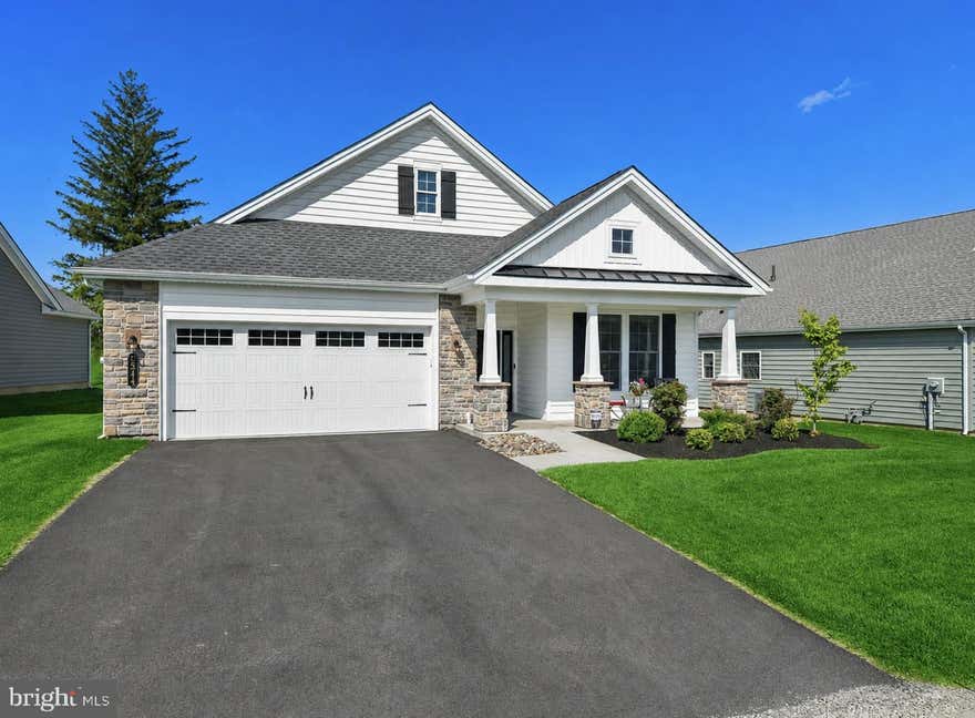 Live the life you have dreamed of! This impeccably maintained CUSTOM-BUILT home in Traditions of America Locust Valley offers truly effortless, LOW-MAINTENANCE, RESORT-STYLE living. CLUBHOUSE AMENITIES include heated outdoor pool, fitness center, tennis/pickleball courts, walking trails, and an active neighborhood calendar. The Grant model features FIRST FLOOR living with an OPEN CONCEPT layout, including a spacious primary suite with spa-inspired bathroom, walk-in closets and custom built-ins. A chef’s kitchen with premium KITCHEN AID appliances, QUARTZ COUNTERTOPS, and an oversized island flows seamlessly into the living area. Random width engineered hardwood floors are found throughout while CATHEDRAL CEILINGS and 6’ elongated windows enhance the airy, open feel. Step outside to a private patio—perfect for quiet mornings or evening gatherings. Ideally located, Locust Valley combines COMFORT, style, and CONVENIENCE in the heart of the Lehigh Valley. Bring your TENNIS RACKET AND GOLF CLUBS but leave your lawnmower behind.