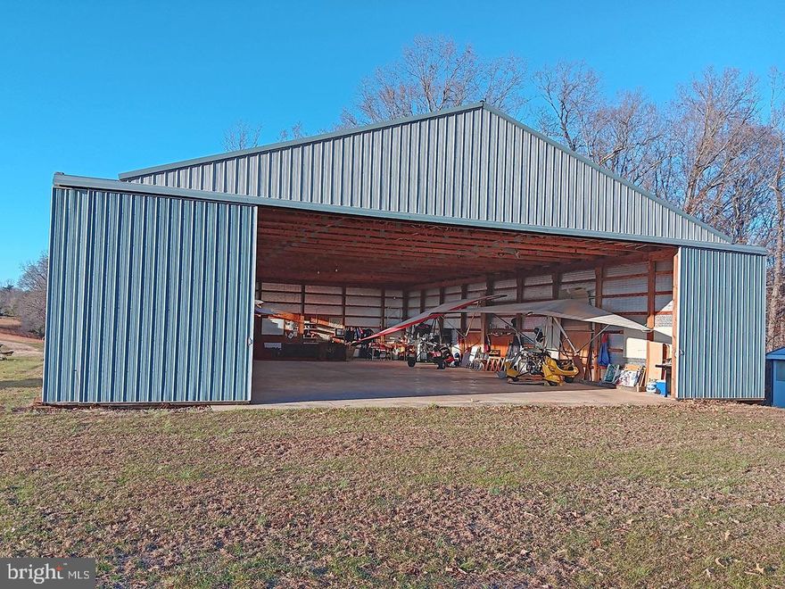 Experience the beauty and versatility of this exceptional 73±-acre property along the scenic Buffalo River in Amherst County, Virginia. Offering approximately 58± acres of open fields and nearly 3,000+/- feet of river frontage, the land features gently rolling terrain, Blue Ridge Mountain views, and the rare advantage of a registered private 1,700-foot grass landing strip. Originally developed for hang gliding and ultralight aircraft, the runway also accommodates small planes, making it ideal for both recreational and light aviation use.

A 50'×72'± insulated metal hangar with a concrete floor provides excellent space for aircraft storage, a workshop, or studio use. For those not focused on aviation, the expansive open acreage is perfectly suited for creating a farm, private retreat, or hunting preserve. The property is rich with wildlife, offering outstanding sport and recreational opportunities.

Infrastructure includes underground electric, a private well, a four-bedroom conventional septic system, and a shed equipped with a modern bathroom and shower. Enrolled in land use for very low taxes, the property is positioned just 45 minutes south of Charlottesville and 20 minutes north of Lynchburg, offering aviation, agricultural, and recreational potential in a convenient yet genuinely rural setting.