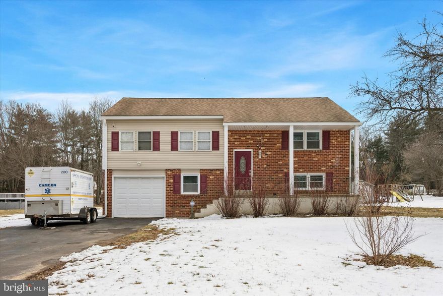 Welcome to this move-in ready split-level home located in the sought-after Pigeon Run neighborhood of Bear, DE. Set on a spacious .79 acre lot, this home offers a perfect blend of comfort, functionality, and outdoor space, ideal for anyone looking to settle into a peaceful suburban setting with plenty of room to grow.

Step up to a raised front porch that overlooks a large front yard, offering great curb appeal and a welcoming first impression. Inside, the main level features three bedrooms and two full bathrooms, including a primary suite with two closets and a private en-suite bath. The bright and spacious living room at the front of the home flows seamlessly into a generously sized kitchen with an attached dining area; perfect for everyday living and entertaining.

Sliding glass doors off the dining space lead to a second-story deck overlooking the expansive backyard: just under an acre of open space to enjoy year-round. Downstairs, the lower level offers even more versatility, with a large second living area, a fourth bedroom, a half bath, and an extra room ideal for a home office, home gym, or additional storage. You’ll also find the laundry room, utility room, walkout access to the backyard, and entry to the attached one-car garage.

Recent upgrades add peace of mind, including new windows, siding, and exterior doors (2025), a brand-new AC unit (2025), updated electrical panel, and well-maintained septic, furnace, and major systems. Whether you're upsizing, downsizing, or somewhere in between, this home has the space, layout, and condition to meet your needs. Don’t miss your chance to make this one your own!