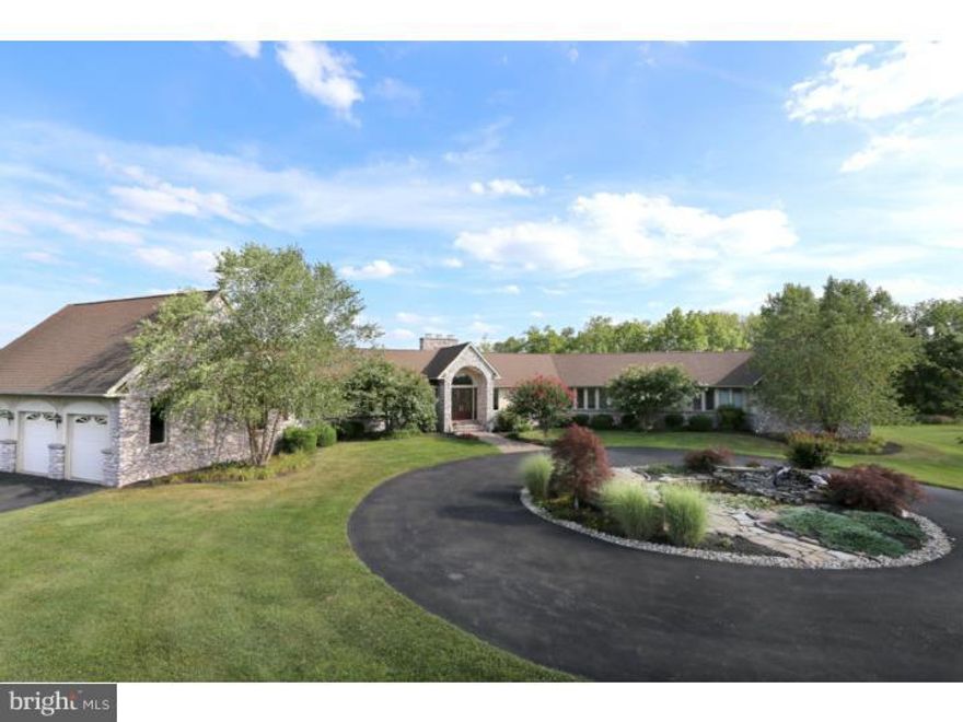 Bright and spacious 5 bedroom home situated on a charming lot adjacent to bucolic Bucks County country land this open floor plan home offers close to 9 000 sq ft of living area between two floors. High cathedral ceilings accented by skylights and fine chandeliers offer a dramatic sun drenched space around the two story stone fireplace in the great room. A southern-facing sun room overlooks the treeline and walks out to the large deck and is enjoyed year round. The kitchen boasts an abundance of cabinets and granite counter top prep space with both a granite island bar and a separate eat-in area. The dining room with wet bar/sink overlooks the neighboring fields. The main level master suite also with a 13' cathedral ceiling has double closets, a fireplace and a full en suite bath with Jacuzzi tub, over-sized walk-in shower and private W/C. Two additional bedrooms on the main level both have their own full baths and walk in closets. Also on the main level is a den/office/study and the primary laundry room. Down the stylish curved stairs alongside the exposed stone to the finished lower level which walks out to the back patio and pool. A well appointed game room with full wet bar awaits including full sink, dishwasher, 2 beermeisters, mini fridge etc. The adjacent TV/Media room area is generously sized and enjoys its own gas fireplace and is open to the billiards room. A full bath right off the door to the patio offers a convenient spot to come in from the pool and there is a second office or bonus room through glass pocket doors. Two bedrooms with full baths and walk in closets are down the hall and a full second laundry room and exercise room round out this floor which has three staircases (one from the garage one from the master suite and one from the great room) offering the potential for a variety of needs including an in-law or au pair suite. Truly a great home to entertain and still be able to find a quiet spot! The pool features two waterfalls and a heated spa with plenty of yard space in the surrounding grounds and a lovely water feature in the circular driveway to greet you every day. A fine home offering lots of flexible living space and gorgeous views awaits...