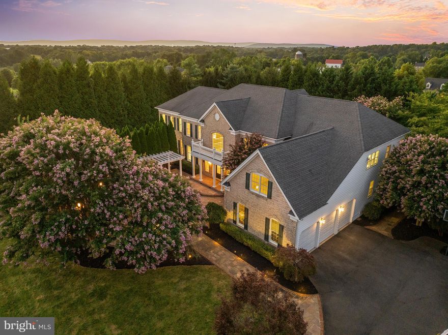 Welcome Home! This stunning estate is situated on a premium 3.25-acre treed lot with beautiful mountain views. Boasting over 6,000 finished square feet on the main and upper levels alone, this property offers exceptional space, privacy, and elegance. The homeowners’ personal touch is evident—over 130 mature trees have been lovingly planted, creating a truly secluded sanctuary. Upon approach the custom courtyard entrance will captivate you—featuring an elegant portico, stunning fountain, and distinctive architectural details- truly one of a kind! Step into the grand foyer, where a dual staircase and soaring ceilings welcome you. The formal living and dining rooms are perfect for entertaining, while the sun-drenched solarium with 3 walls of windows offers year-round enjoyment. Also features desirable main level office with built ins.The heart of the home is the two-story family room, complete with a cozy fireplace, picturesque windows, and skylights. The adjacent enormous gourmet kitchen features plentiful cabinetry, upgraded stainless steel appliances, an extra large center island, granite counters, and a spacious breakfast area. The sunlit morning room with skylights provides the perfect spot for coffee. Step outside to the large custom deck with covered portico that creates an ideal setting for outdoor entertaining or simply relaxing in your private haven, overlooking the private treed yard. Upstairs, you’ll find four spacious bedrooms, each with its own en-suite bath. Two secondary bedrooms include large private sitting rooms—a rarely found luxury. The Primary suite is a true retreat, featuring a grand sitting area with pillars, tray ceiling, spa-like bath with jetted central soaking tub, dual water closets, upgraded duel showers, and an enormous walk-in bonus room (for extra closet space, sewing/craft room, nursery, or personal retreat). The walkout lower level offers over 3,000 square feet of flexible space—ready to finish with endless possibilities! Once complete, the home could exceed 9,000 square feet of living space. Perfectly situated in the heart of Hamilton- with NO HOA and featuring high speed internet and paved roads. This estate offers serene, country surroundings with convenient commuter access and just minutes to downtown Hamilton, Purcellville, and Leesburg. Nearby to tons of dining and shopping options, award winning Wineries, breweries, the W&OD Trail, the Appalachian Trail and excellent schools!  Don't miss the opportunity to call this home!