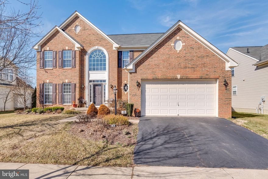 This stunning colonial is in the perfect commuter location to both VA and MD. It features a beautiful brick front with grand arch window. Inside the home you have a two-story foyer with lots of windows and hardwood floors. The formal living room features those same lovely hardwoods. It can be fully enclosed with two sets of doors. This means it would work wonderfully as an office space if needed. It leads you into your dining room with hardwood floors and a decorative light fixture to define the space. Beyond this you have your large kitchen. Here we have hardwoods and recessed lighting. Your raised panel cabinets provide tons of storage in addition to the pantry. Updated appliances include awesome double wall ovens - perfect for holidays! A large island affords extra prep and storage space. Your countertops are nicely accented by a bold backsplash. The kitchen is open to your breakfast nook and large family room. Your family room features those same hardwoods and tons and tons of windows. The main level also includes a convenient half bath. The laundry room keeps your machines nicely tucked from view and provides storage. You have direct access to the garage. This keeps you and your car out of the weather - yay! Up the bold staircase you have 4 generously sized, carpeted bedrooms. The hall bath includes a double bowl vanity for lots of storage and a tub/shower combo. The primary bedroom includes a private, ensuite bath. Here you have double bowl vanity and water closest. There is a large walk-in shower for busy mornings and a large soaking tub to relax in. The lower level of the home is currently unfinished. It provides tons of storage space. It would work well as a rough rec room or workshop. It could easily be finished for future expansion. There is a ton of potential in this space. Outside you have a large deck of the kitchen. This is the perfect place to enjoy the warmer months and host many, many BBQ's. Stairs walk down to your lush rear yard. The lot is nice and level, making it a great place to run and play. This home has so much to offer! Don't wait - Call for your showing now!