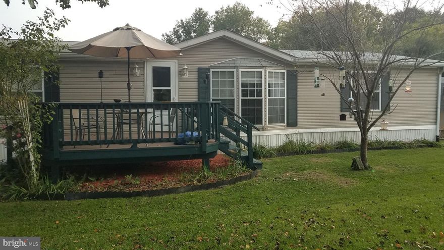 Very Nice 3 BR,  2 BA double wide manufactured home in Hillandale Homes. New wood flooring, new carpet in the 2nd and 3rd BR. All appliances are only 3 to 5 years old. 4 car carport and a nice shed located in the back of the very flat yard that backs to woods. Shed has electric. Site rent is $661.00 per month which includes water, septic and trash removal 2x per week. Must be approved by Community Manager.