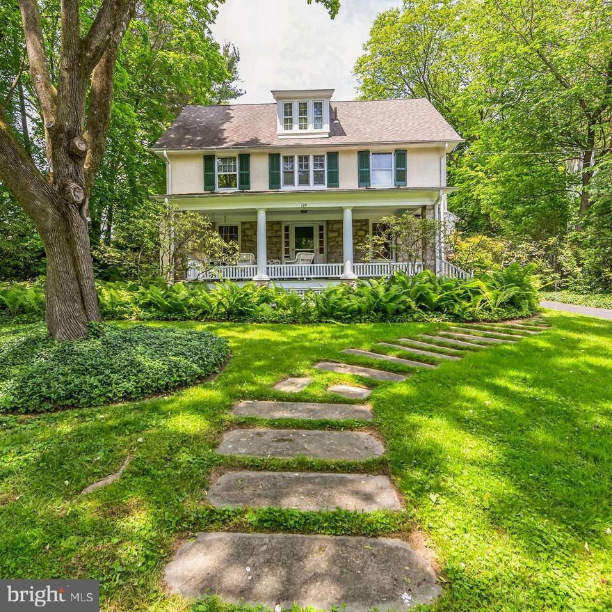 Welcome home to 129 Ogden Avenue –an exceptional, updated Colonial located on one of the most coveted streets in Swarthmore. This stunning 6 bedroom, 3 full and 2 half bathroom home sits on a gorgeous, elevated, large private lot that is landscaped with specimen trees, plantings and shrubs. Curb appeal and quality craftsmanship exude from this freshly painted, grand 3-story home with an inviting stone walkway and a lovely covered front porch complete with swing. Enter this meticulously cared-for home into the elegant foyer and observe the natural sunlight, hardwood floors and graciously apportioned rooms. To the left is the living room featuring box bay windows with copper roofing, built-in bookshelves and cabinets and a wood-burning fireplace. Across the hall is the dining room with a custom chandelier and carpentry details, providing a great space for gatherings and celebrations. Follow the hallway to the spectacular eat-in chef's kitchen—a focal point of this home featuring professional-grade appliances including Wolf dual-fuel oven, second Thermador oven, SubZero refrigerator and Cove dishwasher. Delight in the custom KountryKraft cabinets made from Pennsylvania cherry, granite countertops, a second bar sink, and center island at table height with custom-made chairs, all under a copper roof! Around the corner is a charming powder room with subway tile, and beyond that is a cozy family room with fresh carpet, built-in bookshelves, overhead reading lights, plenty of windows and a wood-burning fireplace. Off the back door is a small patio with a nearly-new Weber Genesis propane gas grill. The second floor of this home boasts a lovely primary suite with a luxuriously updated bathroom featuring a stall shower with two shower heads, pretty tile and a custom vanity. There are 3 additional bedrooms on this floor, each with hardwood floors; two of the four bedrooms have ceiling fans. A large hall bathroom with soaking tub completes this floor. On the 3rd floor, discover 2 more spacious bedrooms with ample closet space and a full bathroom with a tub shower. The unfinished basement, with a half bath, built-in closet, workbench, and egress to the backyard, houses the updated systems including a Weil McLain heater and recently installed professional-grade SpeedQueen washer and dryer. There is plenty of space for storage, including a wall of wine racks and an outlet for a wine cabinet, as well as a refrigerator and freezer. The large backyard offers endless potential for family fun and activities. It includes a wonderful detached garage and a playhouse that both have electric service and the potential to become an accessory dwelling unit (ADU). One of the most outstanding features of this home is the wonderful privacy it offers. It is truly a special place. Perfectly located in the highly sought-after Wallingford-Swarthmore School District, it is within walking distance of the Swarthmore train station and offers quick access to the Philadelphia Airport and major highways.