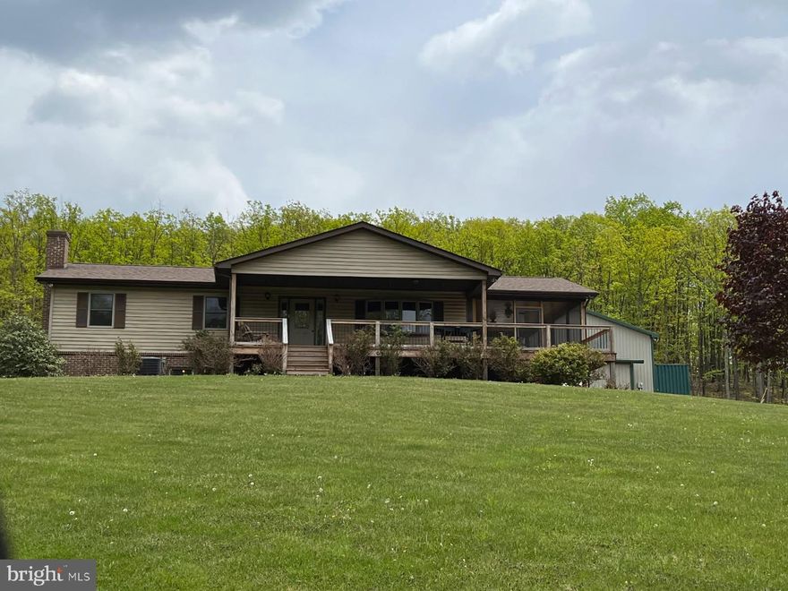 Seller sadly being relocated and must give up his dream home. Great opportunity to surround yourself with peace and privacy on this very secluded 20.91 -acre homestead. With No HOA and No Restrictions this property has endless possibilities. Discover the perfect blend of comfort and self-sufficiency with this well-maintained rancher on a full basement, nestled on 20.9 unrestricted acres of wooded and cleared land. Enjoy the best of country living with modern conveniences and off-grid potential! House features 3 bedrooms and 2.5 bathrooms with a potential 4th bedroom on the lower level. Heat with heat pump or outdoor wood or coal boiler for efficiency and flexibility.  The 2022 Crown Royal outdoor boiler supplies ample heat and hot water, and the woods provide plenty of fuel for the fire!  Enjoy watching the abundant wildlife while sitting out on the 10' by 28' covered front porch.  Barbecue on the 10' by 14' patio, and enjoy the outdoors without the bugs on the ample 14' by 28' screened porch with insulated ceiling, ceiling fans, 
 & electric outlets, Screen EZE tight System for easy maintenance.  The kitchen is equipped with fingerprint resistant stainless steel GE Profile appliances, propane stove with double ovens and wired for electric stove, new commercial grade washer/dryer with warranty. Let's not forget to mention the 30' by 40', heated, 3 bay garage with 14' ceilings and 13' doors. Perfect for personal or business use. House and garage have separate electric meters. Septic was updated to include 4-100' lines. Newer Kinetico Water Treatment System with added Reverse Osmosis and roof with Architectural Shingles (40+ yr). Loads of storage space and much more.   Must see to appreciate. This is the perfect property for outdoor enthusiasts, hunters, homesteaders or those seeking a peaceful retreat.  Perfect set up for starting a home-based business.  Located in close proximity to Wildlife management areas Short Mountain & Nathaniel Mountain. Frontier and Starlink internet available.  A switch in the primary bedroom operates all outside floodlights!   and shipping container do not convey but buyer may purchase in separate transaction.