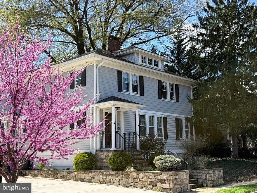 Timeless charm meets everyday comfort in the heart of Lyon Village. Nestled beneath a stunning canopy of mature trees, this inviting 1928 Four-Square beautifully blends classic craftsmanship with thoughtful modern updates. With four bedrooms and three baths, this exceptional home is rich in character, showcasing stacked crown molding, beveled glass windows, period-inspired fixtures, elegant ceiling medallions, an original staircase banister, and gorgeous 3-inch oak floors throughout.
A lovely flagstone and brick walkway leads to the solid wood front door, complete with an antique brass knocker—an entry that sets the tone for the warmth and character found inside. A gracious formal living room, centered around a fireplace with a beautifully detailed white wood mantel and tiered corbels, creates a warm and welcoming place to gather. 
French doors open to a convenient home office, offering a private and inspiring work-from-home space, while the formal dining room easily accommodates gatherings large and small with seating for ten.
At the heart of the home, the sun-filled kitchen is both timeless and functional, bathed in soft natural light and designed for everyday living. Crisp white cabinetry, sleek black countertops, and rich hardwood flooring create an elegant yet comfortable space, opening seamlessly to the expansive family room and casual dining area. French doors invite you outdoors to a private patio and beautifully landscaped backyard—perfect for quiet mornings, alfresco dining, or entertaining guests.
Upstairs, the spacious primary suite offers a peaceful retreat, with room for a sitting area and a spa-like bath featuring a soaking tub and separate shower. Three additional light-filled bedrooms and a well-appointed hall bath provide comfortable accommodations for family and guests alike. A walk-up attic offers excellent storage, while the lower level includes a recreation room, laundry area, wine room, and additional storage space.
Outside, the beautifully designed backyard is framed by handsome retaining walls and complemented by a large detached garage equipped with an EV charger—an ideal finishing touch to this gracious Lyon Village home.