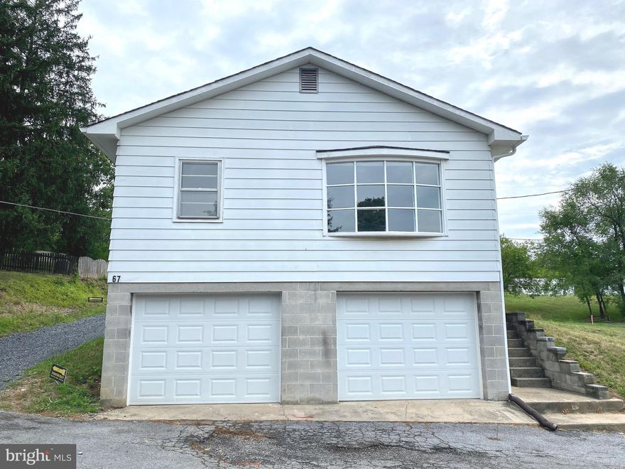 Charming 2 bedroom, 1 bathroom rancher with basement garage!  The kitchen has brand new appliances! This home has an ample sized living room and bedrooms.  Below that you will find the oversized basement garage with space for rooms, a workshop, or for whatever suits your lifestyle.  Within the last two years this home has been upgraded  and tastefully remodeled  to include 2 new garage doors, gutters and downspouts, new carpet, & paint, in addition to upgraded lighting and plumbing fixtures. It's like new! This home  is conveniently walk-out level making for easy living. There are 2  gravel parking spaces in front of the home and a charming concrete covered patio perfect for your BBQ grill with space for your outdoor furniture on which to relax and enjoy the country scenery.