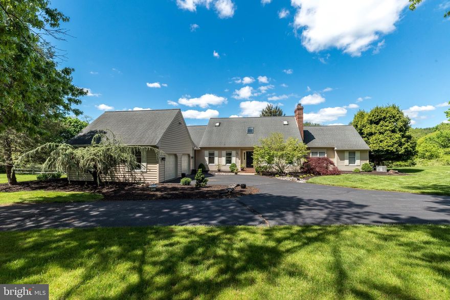 Welcome to your dream residence at 10 Paddock Drive, where elegance meets meticulous maintenance on nearly 3 acres. This exquisite home features 4 bedrooms and 5 bathrooms, offering a perfect blend of luxury and comfort across 3,624 square feet.

Upon entering, you are greeted by a graceful foyer leading to a formal living room and a dedicated home office. The distinguished dining room, with its lush backyard views, seamlessly connects to a gourmet kitchen boasting two spacious pantries and a charming breakfast nook.  Sliding doors open to an inviting outdoor living space which overlooks the Sylvan free-form pool. The perfect spot to dine al fresco under the awning and enjoy the landscape.

The family room exudes warmth with its cathedral ceilings, brick fireplace, and exposed beams, complemented by a wet bar perfect for entertaining. 
The main floor primary suite is a true retreat, with expansive windows, a private deck entrance, cozy fireplace, and a luxurious ensuite featuring a jacuzzi tub and separate vanities. 

In addition, the main floor hosts a thoughtfully planned out mudroom and separate entrance. This space includes a private powder room, 2 large closets and access to the 2 car garage. You will find a second powder off the foyer as well. 

On the second level, 3 spacious bedrooms with ample closet space await. The full bath with double vanities showcases neutral tile and a tub shower. This level boasts plenty of storage space and a large cedar closet. The home's neutral tones and abundant natural light create a warm and welcoming atmosphere throughout.

Additional highlights include a full basement with high ceilings and walk-out access to the pool. This includes a finished bonus room with a full bath and creates the perfect place for pool guests to use. 

Looking for a bit of peace and quiet? Stroll in your own backyard to the pond and take in the beauty and tranquility of your home.  Located near the charming river towns of New Hope and Lumberville, and in the New Hope-Solebury School District, this delightful neighborhood offers a peaceful and high-quality lifestyle to its cherished residents. Make this your perfect new haven.