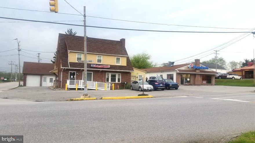 IF YOU HAVE A SERVICE OR A PRODUCT TO SELL ALONG THE BUSY I-83 CORODOR IN SOUTHERN YORK COUNTY, THIS IS THE CORNER PROPERTY WHERE YOU SHOULD BE LOCATED!!
With an Average Daily Intersection Traffic Count of approximately 15,000 vehicles per day, this outstanding busy 0.86 acre, Main St. NW corner location with approximately 380' of combined road frontage on one of the busiest corners in town, this is where you should really be considering! Commercially Zoned parcel, being sold as an existing use, or one of the best located Future Land Redevelopment Sites available in the entire area.  There are currently no tenant occupied units.  One concrete block building, approximately 1200 sq/ft, with natural gas heat and central AC was previously leased to Domino's Pizza (which has relocated to its new location immediately adjacent to the North of this property.  the remaining 2400 sq/ft is currently used as garage and storage space,  another brick building consisting of a 400+ sq/ft brick building that could be an office, repair shop, etc., and a two-story 2300 sq/ft brick office building sitting right on the corner!  Other commercial business in the immediate "Market Square" intersection consist of CVS Pharmacy, Wellspan Medical, Rutters, Rite Aid, Dunkin Donuts, SubWay, U S Post Office, YMCA, Goodwill, General Dollar, Rite Aid, the Market Square Shopping Center, along with many additional local commercial businesses.  Located just two miles north of the MD/PA Line and just off of Interstate I-83, you wont find a better "high visibility, "high traffic" commercial location available in this town! Call now to find out more about this great commercial property!