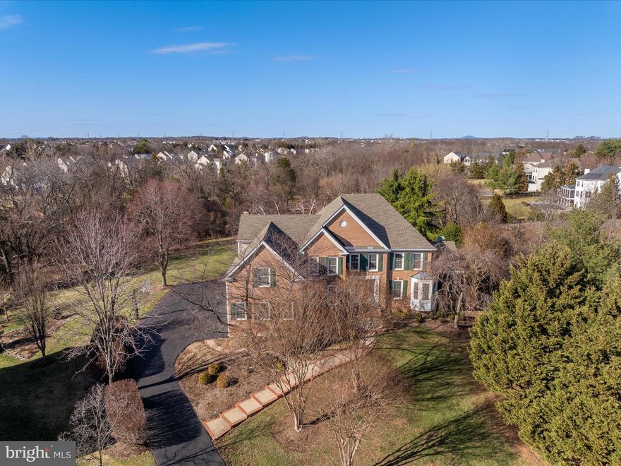 This home was previously under contract and appraised above current list price. Buyer financing fell through, no fault of the property // Welcome to this exquisite colonial-style home in the heart of Ashburn, VA, offering an impressive 5,700 total finished square feet, including a spacious walkout basement with additional basement storage. Situated at the end of a cul-de-sac, on a rare nearly one-acre lot with a completely private backyard providing over an acre to enjoy.  This property is a true entertainer’s paradise, featuring a resort-style backyard complete with an oversized pool, fire pit, hot tub, waterfall, and expansive patio space—perfect for gatherings or relaxing in your private oasis. Inside, the thoughtfully designed floor plan offers both elegance and functionality. The main level boasts recently updated hardwood floors, a sunroom, a dedicated home office, and a spacious family room with soaring ceilings and a cozy fireplace. The gourmet kitchen features granite countertops and an island with bar seating, seamlessly flowing into the formal dining area. Upstairs, you’ll find well-appointed bedrooms and updated bathrooms, including a luxurious primary suite with a spa-like ensuite bath. The lower level offers a sprawling walkout basement, complete with a fully equipped gym, media room, and an open recreation area, along with ample storage space. Additional features include recently updated windows, plush carpet updates, and a rare three-car garage, providing ample storage and convenience. Improvements by date: Re-plastered pool (2024), windows (2022), water heater (2020), lower furnace (2019), bathroom remodels (2021), garage doors (2020), hardwood (2020), and roof (2015).  Located just a short drive from Dulles Airport, One Loudoun, and the highly coveted amenities of Ashburn, this home offers a perfect blend of privacy and accessibility, with exceptional schools, shopping, dining, and commuter routes just minutes away. Virtual tour and floor plans available! Don’t miss your chance to own this extraordinary home.