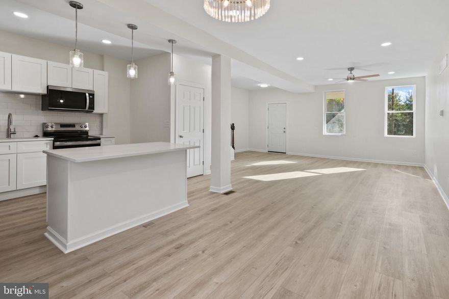 Beautifully remodeled home in 2025 with an undeniable airiness throughout the home. Open first floor with plenty of space for living, dining, and spending time in the gorgeous new kitchen. The large island with quartz countertop provides the room to prep your favorite meals and even entertain for gatherings.  Brand new LVP, fresh paint and new lighting through out the home. There is a half bathroom on the main floor. On the second level you'll find the laundry hookup - no more lugging the clothing basket up and down multiple flights. The primary suite is large and airy with its own ensuite with marble tiles. Upstairs you'll find 3 more bedrooms and a 2nd full bath. The back yard has a privacy fence. This house is ready to be loved by you, so come and make this one your own.