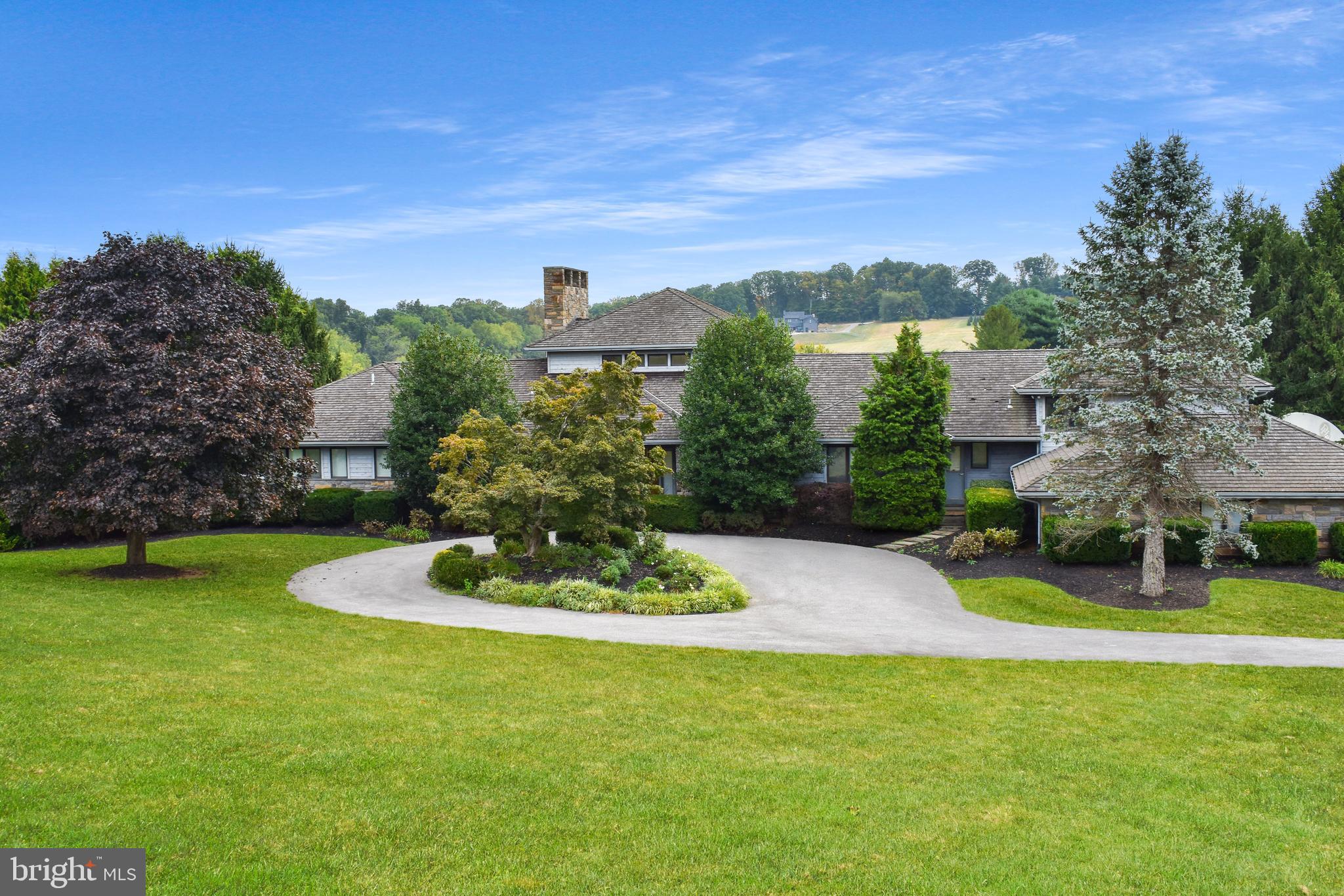 Proudly presenting this custom crafted home on a spectacular five + acres Boasting exquisite views from every window, this lot offers unparallelled beauty. Step inside and enjoy the 29 X 25-foot great room with massive fieldstone fireplace and wall of windows- breathtaking! The vistas include a large pond(though not on this property)- a private oasis. The rooms are all spacious and this expansive home boasts a first floor primary ensuite with study, updated kitchen, covered screened porch, grand dining room, three additional large bedrooms, multiple fireplaces, four full and 1 half baths, The lower level offers no disappointment with, fireplace, wall of windows that lead to rear yard and inground pool. Abundant storage and closets throughout this home. Car enthusiasts will enjoy the 6 car attached garage. Professional photos will be available 9/30/2024