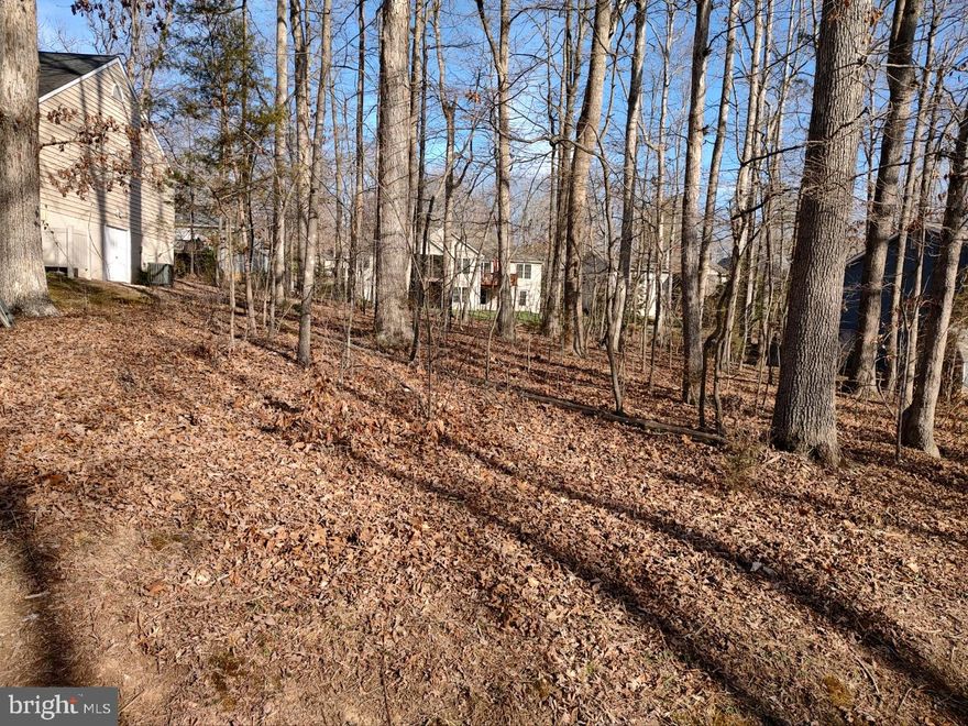 Gentle sloping lot in a quiet lake neighborhood. Wider than most lots at 80 feet. Flexible lot for your chosen  building house plan. Located across street from a main lake cove & at a cul de sac. Just a short Walk to Skyline beach; Quiet  neighborhood close to the gate & clubhouse in the community of .Lake of the Woods ,  LOW is a  2700 acre community with 4260 lots and 3900 homess; is located between historic Fredericksburg and Culpeper & approximately 60miles to DC, Charlottesville, & Richmond. Enjoy boating, swimming, water skiing, sailing, kayaking, paddle boarding or just RELAX at the parks, beaches & walking trails! Play a round of golf on the 18 hole PGA course & stop in Fareways Cafe  for a drink. The Club House offers fine dining, a grill room, patio dining & pub/bar. Pickle ball & tennis are popular sports for every age. This amenity rich community has PUBLIC water & sewer; onsite fire, rescue, & security; offers a 500+ acre Lake with Marinas & a 35 acre fishing lake. . Enjoy theater performances by talented residents at the Community Center ; Approx 50+ civic, service & social clubs are always looking for new members! Community Center campus includes a 2nd pool, playgrounds, soccer fields, fitness trail & picnic pavilion. Don't miss seeing the Equestrian Center where you can take a lesson, a trail ride or board your horse. Looking for a new construction or existing home in a Community with a relaxed lifestyle------ visit Lake of the Wood