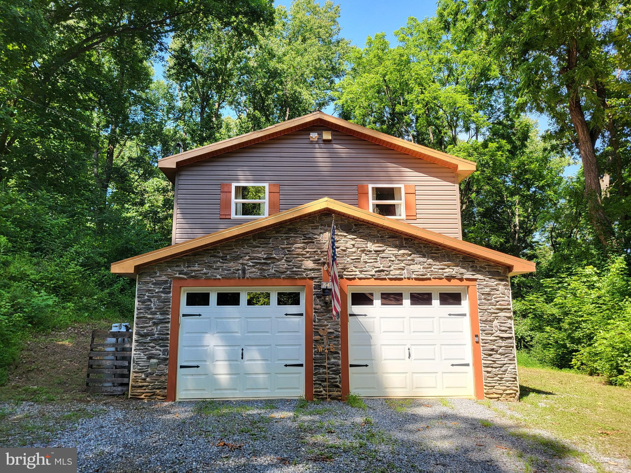 Secluded end of cul-de-sac home in the quiet Potomac Heights Community with integral 2 car garage, on 1 wonderfully wooded acre, just south of Hagerstown in Falling Waters WV. Newly constructed in 2017, this lovely home is located just 3 miles from shopping and restaurants.
Exterior boasts maintenence free vinyl siding, stone veneer, metal roof and Trex decking.
Open concept LR, DR, Kitchen is accented with cathedral T&G wood ceilings, gas fireplace, upgraded cabinets, and sparkling granite countertops. LR French doors open to balcony overlooking a very private, fully fenced backyard with a special feature!
Owner's suite boasts a walk-in closet with laundry, carpeted floors, and vaulted ceilings; while owner's spa bath warms your feet with heated tile floors and decorative Listello accent. What a relaxing space! WOW!
Lower level offers a tiled full bath as well as a scenic walkout to the rear patio with brick paver surface, featuring the gem of the property...an inground pool with pool house and a season-extending pool heater! Â
If you're awake, you'll hear the owls hooting in the morning!