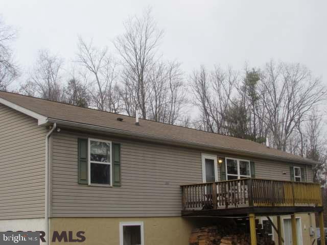 Enjoy privacy & beautiful views from this 4 bedroom Ranch home on a wooded 18 acre lot . Home features first floor master and master bathroom with soaker tub and shower. Family room features propane fireplace. Kitchen features breakfast bar . Laundry room just off the kitchen area. Beautiful views from the front deck . Home has an outdoor furnace to keep the home very toasty in the winter & save on heating cost. Larger 2 car garage / workshop. The home also features a workshop or exercise room.