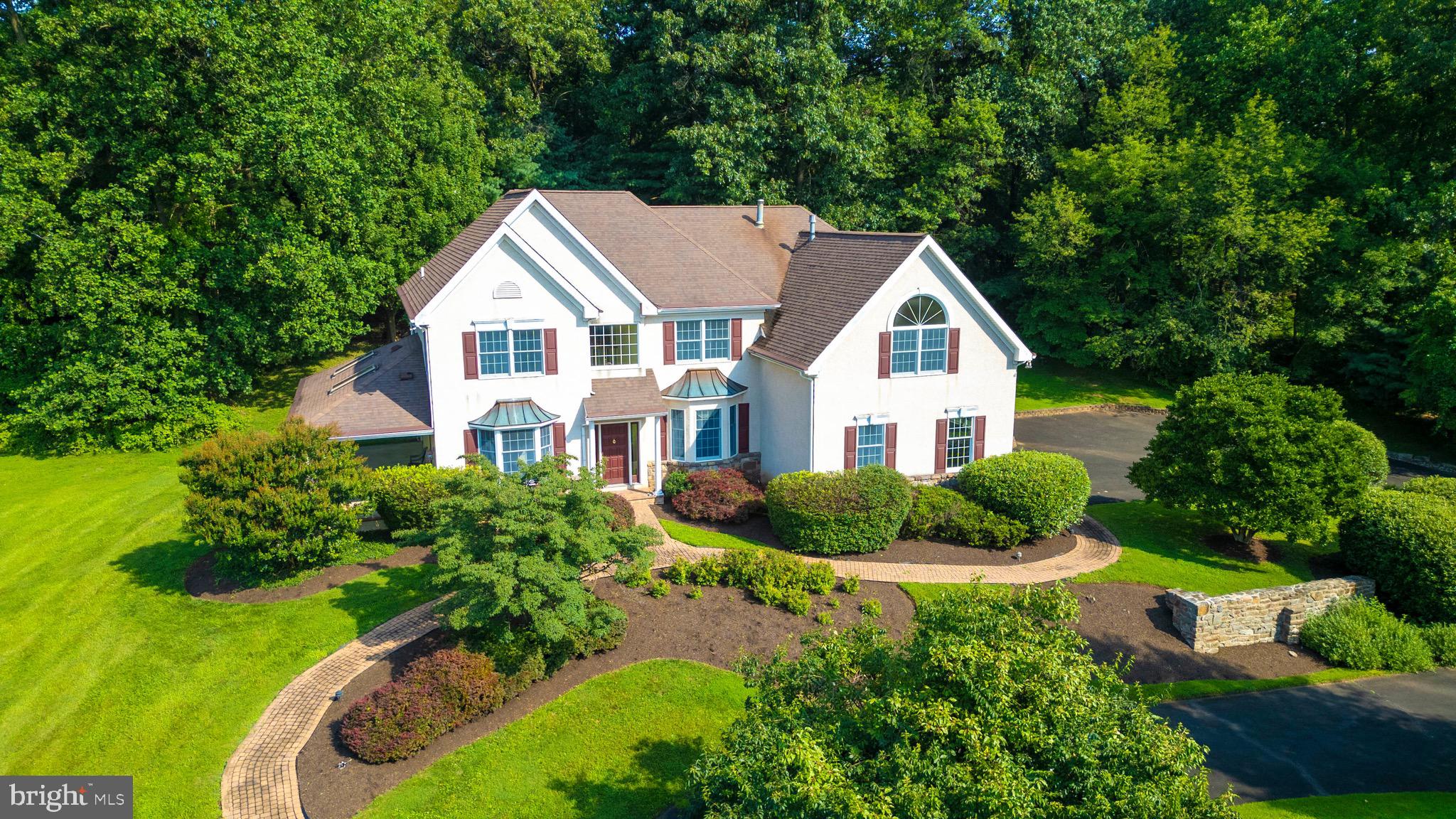 Welcome to 2160 Huntingdon Road, an exceptional colonial residence nestled on 3 serene and private acres in the heart of prestigious Huntingdon Valley. This elegant 4-bedroom, 2 full and 2 half-bath home offers a perfect blend of timeless charm and modern comfort. A circular driveway, paver walkways, and a 2-car attached garage create an inviting first impression. Step inside to a dramatic two-story foyer that sets the tone for the gracious interiors beyond. The main level boasts formal living and dining rooms, a private home office, and a stunning vaulted-ceiling great room adorned with custom built-ins, a cozy fireplace, and a bar sink—ideal for gatherings and everyday living. The gourmet kitchen features gleaming granite countertops, a spacious island, pantry, ceramic tile finishes, and a sunny breakfast room that opens to the rear deck. Gleaming hardwood floors flow throughout the main level, while French doors from both the living room and office lead to a charming 12' x 30' covered side porch—perfect for relaxing or entertaining in all seasons. Upstairs, the luxurious primary suite is a true retreat, offering a tranquil sitting room with built-ins and a decorative fireplace, generous closet space, and a spa-inspired bath with Jacuzzi tub, stall shower, and double vanity. Three additional bedrooms share a tiled bath. The finished basement adds even more living space with a second powder room, a cedar closet, and a large storage room with built-in shelving. Additional features include 2-zone hot air heating and 2-zone central air for year-round comfort. Enjoy a lifestyle of convenience and natural beauty—just minutes from the PA Turnpike, shopping, and the scenic trails of the Pennypack Ecological Restoration Trust. Terwood Park, Mason’s Mill Park, the Willow Grove YMCA, and the regional rail station to Center City and Philadelphia International Airport are all nearby, making this a truly special place to call home. Available immediately.