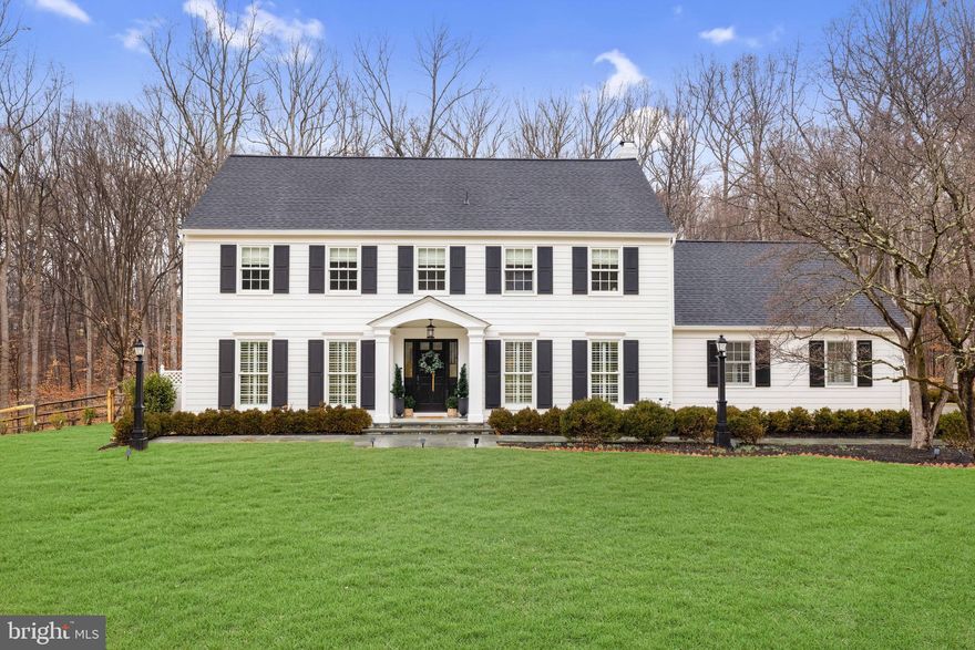 Welcome to 8701 Belmart Road, a classic colonial fully renovated to modern taste and comfortable style perfectly nestled on a cul-de-sac in the distinguished neighborhood of Potomac Falls located in Potomac, Maryland. This four bedroom, two full and two half bathroom home features 4,500 square feet of space on nearly two and a half acres of land. Complete with a gracious and open floor plan for entertaining, a newly designed mudroom, brand new fitness room and fully updated outdoor pool, this home is turn-key and no project left behind. 

Enter the front door into the main foyer beautifully wrapped in hardwood flooring that can be seen throughout the main and upper levels. The foyer showcases custom trim work  also appointed throughout the home. Walk through the french doors into the living room where natural light beams through the oversized windows wrapped in plantation shutters. The gorgeous family room addition showcases the open floor plan everyone is looking for. Walls of windows and sliding glass doors highlight the stunning wooded views this lot has to offer. The generous family room with gas fireplace wrapped in stone opens to the kitchen, dining plus an additional living space.  This gourmet kitchen includes a six-burner Viking Stove, dual sinks, brand new refrigerator, granite countertops, custom tile backsplash, and an island with bar seating for two. Dining for a larger group is no problem with the sweeping table space.  Brand new custom cabinetry wraps the side wall providing tremendous pantry space for all of your storage needs. A main level office with glass doors offers bright and sunny views through and a wall of built-in cabinetry. The convenient mudroom sits adjacent to the kitchen with dual washer/dryers, sliding doors with additional storage space, powder room and a glass door for backyard access. The original garage has been transformed into an impressive fitness room and recreation space while still providing multiple closets for storage, an additional refrigerator, and double glass doors to the exterior. A bonus powder room with wainscoting and a hall coat closet can be found off the main foyer.

Follow the hardwood flooring to the upper level where four bedrooms and two full bathrooms can be found. The hallway is elegantly wrapped in chair-rail molding and hosts a modern chandelier. The primary suite showcases treetop views through picturesque windows and designer window treatments. A walk-in closet is complete with built-in shelves, while an additional closet can host those extra items. The updated en-suite bathroom showcases a steam shower, custom vanity with granite countertop, ample cabinet space, tile flooring, custom window treatments and a built-in towel rack. Three additional bedrooms round out this level, all complete with designer window treatments and double-door closets. A linen closet and full bathroom with oversized tile floors and a shower/tub can be found off the hall. 

The lower level is the ideal space for an additional lounge area and is covered in tile flooring. This level has been improved with an oversized walk-in closet that offers the extra storage space you need to stay organized. The pool has been fully updated with a new liner, tile coping, heat pump, cover and a new storage shed that was conveniently added to the side of the house to host any larger items. The fully fenced yard offers wooded views throughout and backs to Great Falls National Park. 

This picturesque lot is ideally situated, just minutes away from I-495 & Clara Barton Parkway, the Potomac Village and the C&O Canal. With all this impeccably maintained home has to offer in such a prime location, it will surely not last! Do not miss this rare opportunity.