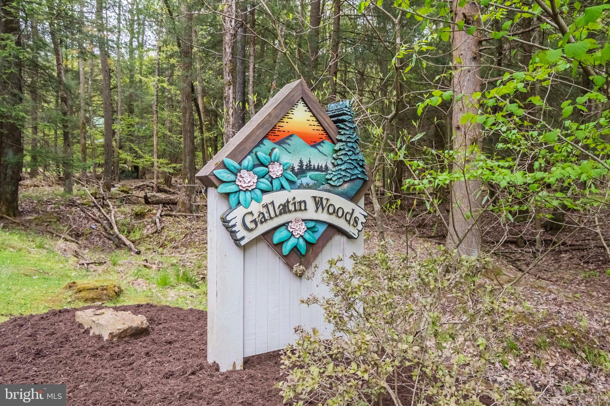 Gallatin Woods is a unique log home community located on Lakeshore Drive in the innermost part of Deep Creek Lake. Each owner may build within the building cylinder indicated on the plat and have exclusive use of the parking area and the additional land that immediately surrounds the home site. All other land within the community is condominiumized to keep the area wooded and carefree. Owners may choose from any of the log home plans offered by Gallatin Woods. Exterior color is a specifically designed natural wood tone. All roofing is green metal and windows have matching green cladding. Community amenities include a stream, pavilion and playground.