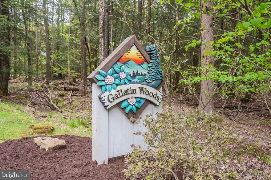 Gallatin Woods is a unique log home community located on Lakeshore Drive in the innermost part of Deep Creek Lake.  Each owner may build within the building cylinder indicated on the plat and have exclusive use of the parking area and the additional land that immediately surrounds the home site. All other land within the community is condominiumized to keep the area wooded and carefree. Owners may choose from any of the log home plans offered by Gallatin Woods. Exterior color is a specifically designed natural wood tone. All roofing is green metal and windows have matching green cladding. Community amenities include a stream, pavilion and playground.