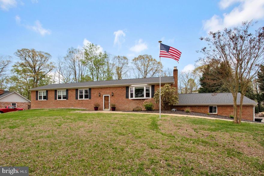 BACK ON THE MARKET: HOME INSPECTION WAS PERFECT. Buyers plans changed. 
Quality built brick home on huge 1.0 acre lot tucked away in a private oasis.  Three sides of this gorgeous home are surrounded by land and trees offering natural beauty and wildlife viewing opportunities. The end of the back lot offer water views! Your peaceful escape begins as you enter the long driveway, leading to a driveway with an oversized parking pad and an attached two-car garage. Over 3848 Square Feet if living area. Garage not included in square footage.  The foyer leads to a stunning living room with a beautiful fireplace and with tile surround, an adjoining dining leads to beautiful kitchen includes upgraded countertops, microwave and oven,  Refrigerator and Dishwasher. Lovely Wood Custom Cabinets. The owner's suite boasts new flooring and closet doors. Massive private bathroom with a soaking tub and separate shower.  Secondary bedrooms are very generous in size. Second Kitchen hookups and plumber are in new home gym on bottom level. Perfect for an apartment or au-pair suite.  Entertainment has no end in this home. Large family/game room is on the bottom level of this massive home. Guest Room, Laundry area and walkout to oversized two car garage. The dream yard features mature landscaping, a large partially covered deck, perfect for guests, large Pool Parties or intimate cookouts. Cozy Stone Firepit and Basketball court adds to your outdoor experience.  Sellers have put over 100K in upgrades. New Roof, Pool Filters, Plumbing, Water Softener, Radon Mitigation System, HVAC  and SEPTIC System (2022 & 2024). The secondary bedrooms have new flooring are generous in sized. This meticulously cared-for home is conveniently located near Washington DC, Joint Base Andrews, Patuxent River NAS, restaurants, and shopping! Close to Annapolis and Chesapeake Beach.