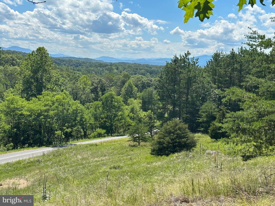 BIG EASY VIEW.....21 WOODED ACRES WITH FLAWLESS LAYERED PANORAMIC MOUNTAIN VIEWS TO THE WEST FOR PRICELESS SUNSETS, TO THE SOUTH YOU'RE LOOKING INTO SOUTH BRANCH MOUNTAIN, PRETTY MUCH 180 DEGREE VIEW. WIDE HARDWOOD RIDGE PROVIDES EASY BUILD SITE JUST ABOVE THE ROAD, SHORT DRIVEWAY & SHORT PULL FOR ELECTRIC = BIG SAVINGS ON INFRASTRUCTURE COSTS. FROM THE BIG RIDGE IN THE FRONT, THE LAND SLOPES DOWN INTO A WIDE SHALLOW HOLLOW AND THEN ROLLS UP GENTLY TO ANOTHER RIDGE AND THEN DOWN TO THE EDGE OF A FARM FIELD. GORGEOUS LOBLOLLY PINES, WHITE OAKS & CHESTNUT OAKS BLANKET THE LANSCAPE.....POWER & PERKED.....HUNT, SHOOT, HIKE, ATV'S, CAMP OR BUILD....ONLY 2 MILES OFF THE PAVED ROAD WITH NO TREACHEROUS ROADS OR MOUNTAINS TO CLIMB....EASY IN...EASY OUT....LOCATED IN THE PRESTIGIOUS 10,000 ACRE GATED COMMUNITY ASHTON WOODS, A ONE OF A KIND PLACE, WHERE YOU CAN ESCAPE THE WORK & WORRY OF THE BIG CITY AND TICKLE ALL YOUR OUTDOOR FANCIES....10 MINUTES OFF 4 LANE SUPER HIGHWAY, 10 MINUTES FROM MULTIPLE PUBLIC ACCESS POINTS ON THE SOUTH BRANCH OF THE POTOMAC RIVER, 15 MINUTES FROM MOOREFIELD, WAL MART, RESTAURANTS, GOLF, THEATER, 45 MINUTES FROM SKI RESORTS, 10 MINUTES FROM PRIVATE COMMUNITY ACCESS TO NATHANIEL MOUNTAIN WILDLIFE MANAGEMENT AREA 10,000 ACRES OF PUBLIC HUNTING & HIKING.....IF YOU LIKE THE OUTDOORS, YOU'LL NEVER RUN OUT OF THINGS TO DO.....WHO KNEW? ALL OF THIS WITHIN 2 HOURS OF DC.....BELIEVE IT! COME SEE FOR YOURSELF! THIS DECISION WILL BE EASY, IT'S A NO BRAINER!