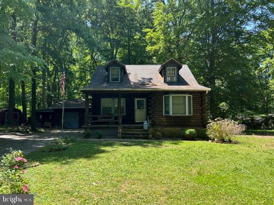 A lovely custom built log cabin home, siting on over 6 acres of land.  The home features 4 bedroom, 2.5 baths.  A basement with a half bath.  There is a large garage, with work benches and a detached tool shed.  This home will not last, so bring your best customer and offer!!!