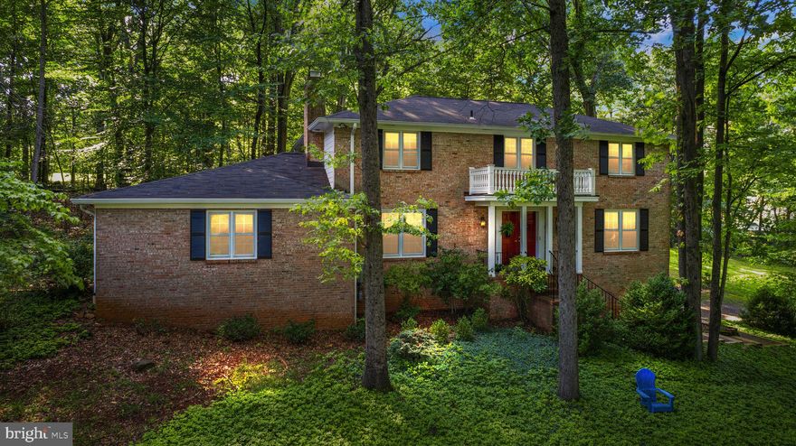 Welcome home to this spacious 4 bedroom, 2.5 bathroom brick front home nestled in a serene lot on over 2.5 acres at the end of a quiet cul-de-sac. This home has beautiful curb appeal, situated on a well-maintained lawn with the driveway and 2 car garage tastefully tucked away to the side of the home. Grand double doors greet you as you make your way through them into the elegant foyer with slate floors and spacious coat closet. Throughout this main level you will fall in love with the elegant Brazilian cherry floors which reflect the abundant natural light pouring through the large windows. The atmosphere of this level is light and bright and provides seamless movement from room-to-room making it an ideal place to entertain and gather with loved ones. The beautiful living room directly to your right is adjacent to the formal dining room with three beautiful windows letting in the light and the serene natural setting outside. The kitchen has ample cabinetry and countertop space with every appliance you need - making meal preparation a breeze! A light and airy breakfast room provides the perfect space for casual dining and features a door leading to the private outdoor brick patio area. Continuing through the breakfast nook you will find a spacious laundry room with cabinets for storage. Enjoy the built-in bookshelves and cozy wood-burning fireplace in the library which is located on the other side of the kitchen. Upstairs you can retreat to the primary bedroom with beautiful hardwood floors, walk-in closets, cooling ceiling fan, and private en-suite bathroom. Three additional, light and bright bedrooms with closet space as well as a dual-vanity full bathroom in the hallway complete this upper level. The lower level of this home includes a finished room - perfect for crafting or hobbies. The remainder of the basement is unfinished - with great potential for a home office or guest suite or also simply as additional storage. Recent updates include fresh paint throughout the entire interior (July 2023), Septic and Dbox (2022), HVAC, Dishwasher, and Washer (2018), Dryer (2019), Roof and Double Oven (2012). Don’t miss the chance to make this private, serene oasis yours today!