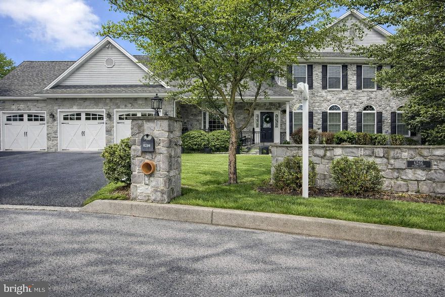 6286 Stable Court • Harrisburg, PA
A Custom Estate of Timeless Craftsmanship & Multi‑Generational Luxury
Perfectly positioned at the end of a quiet cul‑de‑sac on .86 acres of manicured, tree‑lined grounds, this one‑owner custom home blends refined architectural detail with exceptional functionality. From its stone exterior and professional landscaping to its expansive interior living spaces, every element has been thoughtfully designed and impeccably maintained.

A Grand Welcome
A charming front porch and stone façade set the tone for the elegance within. Step into a traditional foyer adorned with tile flooring — an inviting introduction to the home’s warm sophistication.

Main Level Elegance
Formal Dining Room
A custom wrought iron gated entry opens to a beautifully appointed dining room featuring hardwood floors, a bay window, crown molding, wainscoting, and a butler’s pantry complete with wine rack—perfect for effortless entertaining.

Private Office Retreat
Work in style behind a French pocket door in a sunlit office with hickory flooring, wainscoting, and graceful circle‑top windows. A connecting half bath adds convenience and privacy.

Gourmet Kitchen & Breakfast Area
Designed for both culinary creativity and everyday comfort, the kitchen boasts:

Vaulted ceiling with skylight

Quartz countertops & tile backsplash

Large island & walk‑in pantry

Brand‑new GE Profile stainless steel microwave, double ovens, and dishwasher. 

Tile flooring throughout the kitchen area.
All appliances convey, ensuring a seamless move‑in experience.

Great Room Sanctuary
The great room continues the vaulted ceiling theme with two additional skylights, hickory flooring, and a dramatic gas fireplace with a raised hearth and stacked stone rising to the ceiling. Sunlight pours in, creating a warm, inviting atmosphere. Select wall décor will remain with the home.

Just beyond the breakfast area doors to the exterior is a 12'×14'  composite deck (approx. 4 years old) that overlooks the fenced, tree‑lined yard and a charming 3‑year‑old gazebo—an ideal setting for outdoor relaxation.

Laundry Room
Thoughtfully designed with cabinetry, scrub sink, tile flooring, large washer/dryer, and a pocket door.

1st floor Primary Suite
A serene retreat featuring hickory wood floors, a spacious walk‑in closet, and an updated spa‑inspired bath with tile shower, soaking tub, and double vanity.

Upper Level Comfort
Three generously sized bedrooms—each with walk‑in closets—are complemented by a full bath with double vanity and a linen closet. Central vacuum services both the main and upper level.

Exceptional Lower Level Living
A True Multi‑Generational or In‑Law Suite
This remarkable walk‑out lower level offers independent living with two staircases (one with a stair lift) and a separate exterior entrance easily accessible from the driveway with a walkway to the back of the home. Designed for comfort, accessibility, and versatility, this unique quality space includes:

Full kitchen with stainless steel appliances.  All kitchen appliances convey.
Living room with stone accent wall

Three spacious bedrooms or two bedrooms plus an office (all have closets)

Two full bathrooms, including a fully handicapped‑accessible bath with a walk‑in tub making it easy for those with special needs.

Laundry room with folding table, scrub sink & multiple storage areas (Washer and dryer convey)

Bright, above‑ground feel thanks to walk‑out design

Beautiful 3‑season room (only a few years old)

Generator hookup (generator included, never used; not guaranteed)

This level offers endless possibilities—ideal for extended family, guests, or private living quarters.

Additional Notes
A curated list of furniture available for purchase accompanies the home.