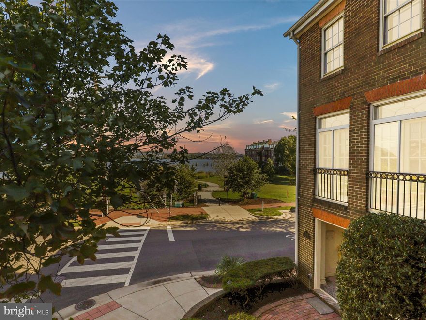 Overlooking the Potomac River and Windmill Hill Park sits this stunning four-story townhome in the coveted South East Quadrant of Old Town Alexandria. With 4 bedrooms, 4.5 bathrooms and nearly 3,500 square feet, you will never be short on space! Originally built in 1968, the home has been beautifully and thoughtfully renovated for a modern feel. From the moment you enter into the grand foyer, you know this is a special home.  A private office, featuring original parquet floors, stunning custom built-ins surrounding a wood-burning fireplace is just off the foyer.  A few steps down from the foyer, a sunken family room with 10 feet + ceilings, custom built-ins, and a wet bar with grand French doors opens to a private walled garden. Upstairs the new open kitchen features a large center island with pendant light fixtures, stainless steel appliances, custom white cabinets and beautiful white quartz. Each bathroom throughout the home has been renovated down to the studs and finished with custom tilework and modern fixtures. The living room is truly spectacular with classic details including crown molding,  chair rails, a wood-burning fireplace with grand mantle and three sets of french doors overlooking the park and river. The views will take your breathe away!  Another wood-burning fireplace is the focal point of the primary suite, which also overlooks the park and has river views and a beautiful new ensuite bath.  Two other bedrooms, one with river views, and an updated hall bath round out the rest of the 3rd level.  The finished upper level includes a newly renovated full bath, laundry/utility room, storage room and a large flex space which could be used as a bedroom, playroom, family room, gym - a space for you to make your own.  Throughout the home all tile floors are new, all hardwoods have been refinished and all lights have been replaced with modern fixtures, including additional recessed lighting.  This home has the most exquisite Old Town location, only a short walk to King Street, with priceless river and park views. Own a piece of Old Town charm with all the modern luxuries!