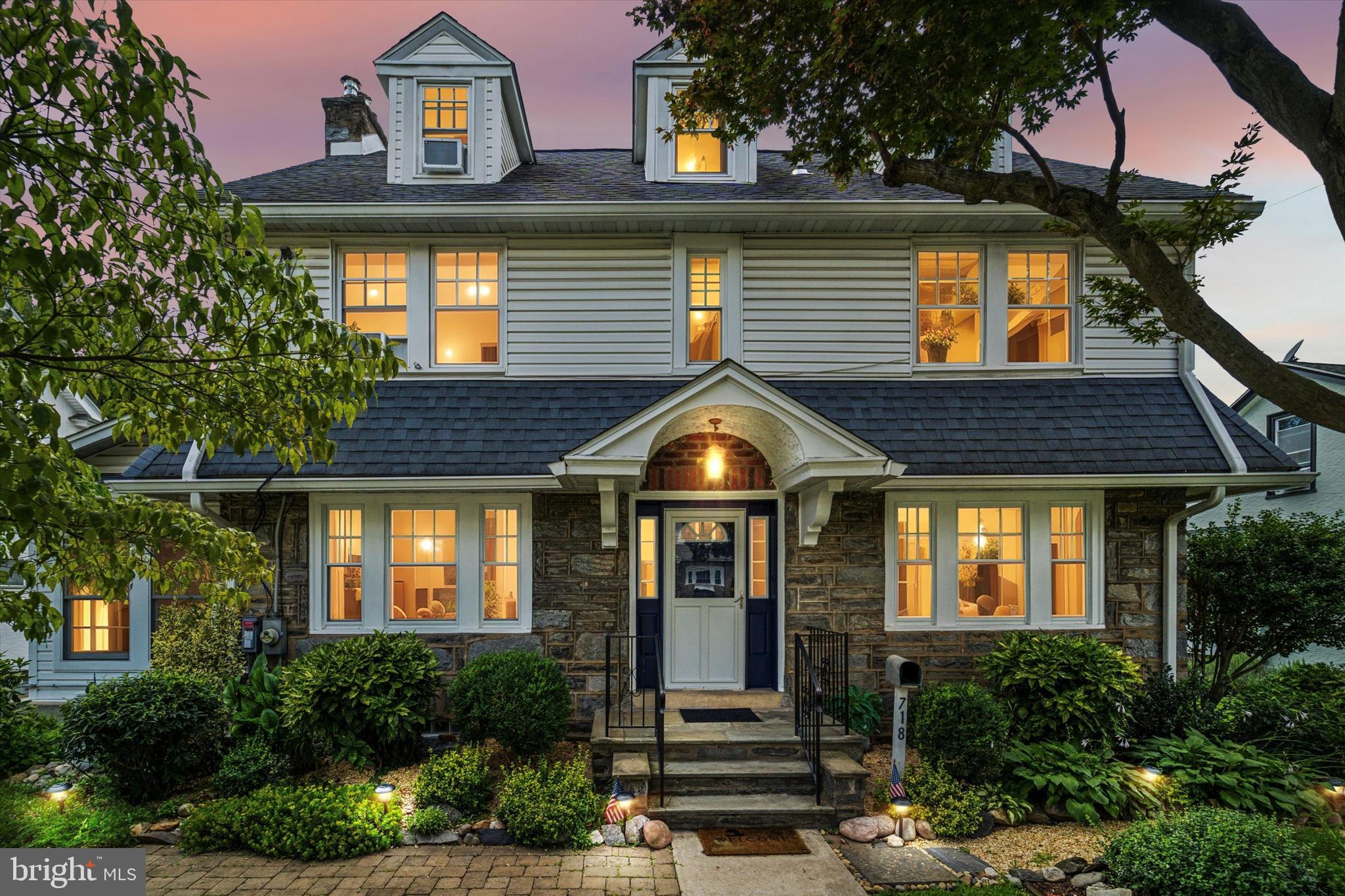 Welcome to this beautifully maintained stone and brick Center Hall Colonial, offering timeless charm and modern comforts across three spacious levels with a Brand New Fence in rear yard. With 6 bedrooms, 3.5 baths, and over 2500 square feet of living space Plus additional basement space, this home is ideal for multi-generational living or anyone seeking room to grow. Step into a gorgeous ceramic tile entry foyer featuring crown molding and French doors that open into the formal dining room and family room, both adorned with brand-new hardwood flooring. The living room is a warm and inviting space, boasting a striking stone fireplace with a wood-burning insert, custom wood dental mantle, crown molding, and dual French doors leading to a bright sunroom filled with windows. The formal dining room features abundant natural light, chair rail detailing, crown molding, deep window sills, and charming split doors connecting to the kitchen. The kitchen blends beauty and functionality in every detail with oak cabinetry, ceramic tile floors and backsplash with decorative accents, granite countertops, stainless steel appliances, a 5-burner gas stove with grill burner, double windows over the sink, pantry storage, vaulted ceilings, and a skylight. The home includes a rear living area with private access—previously used as a handicap-accessible suite—complete with a full ceramic tile bath, pedestal sink, walk-in shower, and large linen closet. Upstairs, the second level offers four generously sized bedrooms, all with hardwood flooring and ceiling fans, plus a full ceramic tile hall bath with a shower stall and with a seat. The third floor adds even more flexibility with additional large bedrooms, a ceramic tile hall bath with a tub/shower combo, and ample attic storage. The partially finished basement expands your possibilities with space currently used as a hobby room or office, bonus and storage rooms, a large half bath, and a laundry area. Outdoors, enjoy beautifully manicured landscaping, paver walkways, garden areas, a rear patio, and an oversized shed off of The spacious driveway which provides abundant off-street parking. Additional features include original high baseboards, numerous ceiling fans, and exceptional storage throughout. This is a great location with easy access to shops, restaurants, Center City and major arteries for all your travel needs. Don’t miss your opportunity to own this character-rich, move-in ready home with space and style to enjoy! Note: Seller IS having the lift removed in rear of home.