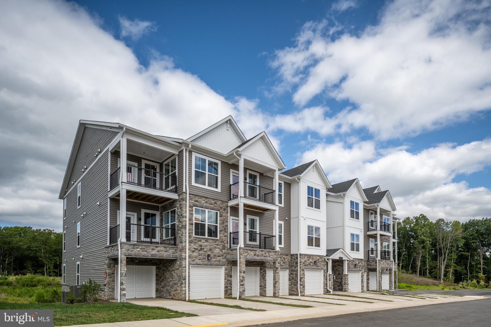Step into refined, single-level living with this exceptional condo in the sought-after Embrey Mill community. Located in a private, secure building with smart video intercom access and individual unit entries, this home offers the perfect blend of comfort, style, and modern convenience. Enjoy the ease of private garages, driveways, and elevator access, along with well-lit storage spaces. Inside, a grand foyer with tray ceiling leads to an open-concept living area featuring a sun-filled family room, high ceilings, and a private balcony. The gourmet kitchen is a chef’s dream, complete with Whirlpool stainless steel appliances, granite countertops, designer tile backsplash, oversized island, walk-in pantry, and smart pull-out shelving. The luxurious primary suite includes a massive walk-in closet and private balcony with hose bib, ideal for potted plants or personal gardening. The spa-inspired primary bath features a double vanity, ceramic tile, and a frameless glass shower. A spacious secondary bedroom, pocket office, large laundry room, and luxury vinyl plank flooring throughout complete this thoughtfully designed home. Enjoy peace of mind with fire suppression systems, and experience seamless living with integrated DreeSmart technology. Embrey Mill offers resort-style amenities, including a clubhouse, fitness center, yoga studio, pickleball courts, fire pits, outdoor games, and an on-site activities director—all just minutes from I-95, Route 1, top shopping, dining, and the new Publix. This is elevated condo living at its finest.