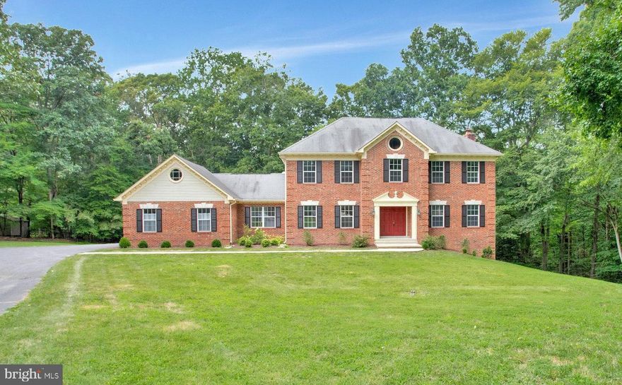 Welcome to this stunning brick-front Colonial in the highly sought-after Smith’s Purchase community, right in the heart of Dunkirk! This home checks every box, beginning with a welcoming main level that offers formal living and dining rooms, a spacious eat-in kitchen with pantry, and a cozy family room with a bay window and wood-burning fireplace. A convenient powder room, laundry area, and mudroom complete the main floor.

Upstairs, the primary suite provides a peaceful retreat with a walk-in closet and a private bath featuring a soaking tub and separate shower. Three additional generously sized bedrooms and a full hall bath complete the upper level. The finished walk-out basement expands your living space with a rec and media room, fifth bedroom, full bath, home office, and workshop—perfect for hobbies or working from home.

The property truly shines outdoors. The expansive backyard offers endless room for football, games, and exploration, while the long driveway and cul-de-sac create a safe, open area for biking, basketball, and outdoor play. Nature lovers will enjoy the shallow creek for discovering fossils and arrowheads, a spring along the hillside, and frequent visits from deer, foxes, and turkeys. A deck provides the perfect space for entertaining, and an outdoor faucet makes it easy to rinse off before heading inside. With nearby beaches like North Beach and Chesapeake Beach, outdoor enjoyment is always just minutes away.

Additional features include a two-car attached garage, ample driveway parking, and the benefit of living in a quiet, friendly neighborhood with no HOA. Located in a top-rated school district and offering an ideal commuter location just 30 minutes or less to DC, Northern Virginia, and Annapolis, this home combines comfort, adventure, and convenience in one perfect package.

Do not miss the opportunity to make this spacious, adventure-filled home yours!