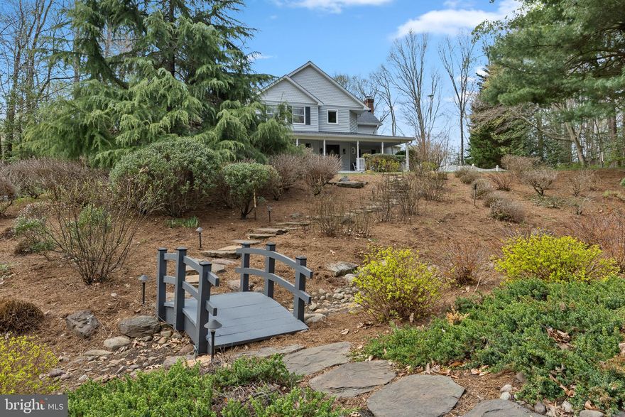 Tucked away on a quiet cul-de-sac, this stunning home feels like a private retreat—inviting you to slow down and truly enjoy every moment.

The charming front porch and beautifully landscaped yard set a warm welcome from the moment you arrive. Step inside to an elegant sitting room filled with abundant natural light.

The main level flows effortlessly for both daily living and entertaining. A spacious living room with a striking brick fireplace opens into a refined kitchen featuring marble countertops, stainless steel appliances, a breakfast bar, and serene nature views from the sink. Nearby, a bright dining nook is perfect for morning coffee, while a formal dining room handles larger gatherings. You’ll also find a private office, stylish wet bar, well-equipped laundry room with ample storage and a drop zone, and a convenient half bath.

Upstairs are three generously sized bedrooms, led by a relaxing owner’s suite with a spacious layout, custom walk-in closet, and spa-like en suite bath complete with double vanity, soaking tub, and separate shower. A second full bathroom—recently renovated with dual vanities and sleek modern finishes—serves the other bedrooms.

The finished lower level adds more space to unwind, with a large carpeted living area and an expansive storage closet that could easily become a wine cellar.

Outside, the backyard truly shines: a peaceful oasis with seasonal water views, a stone patio, hot tub, expansive wraparound deck, and stone pathways throughout. A white picket fence provides charm and privacy, while lush landscaping enhances the natural beauty. An attached two-car garage adds everyday convenience.

Filled with sunlight and inviting spaces inside and out, this home perfectly blends comfort, elegance, and retreat-style living—you may never want to leave.
