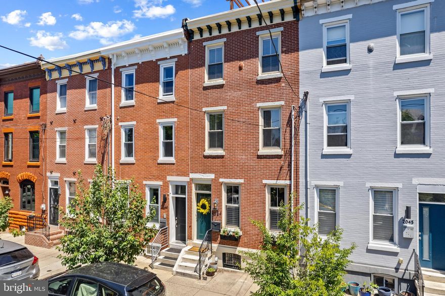 This 3 bedroom 3.5 bathroom property with parking in the heart of Graduate Hospital was lovingly remodeled by the current owners with a focus on classic details, modern design and ease of daily life.

A classic vestibule entrance welcomes you into a bright living room with original pine floors, custom fireplace, and exposed brick. The open layout flows easily through living and dining areas to a large updated eat-in kitchen boasting stainless steel appliances and a farmhouse sink. Off the kitchen is a brick back patio with alley access, currently used for parking.

Up the modern open staircase, the second floor features a convenient laundry area, a bright tiled hall bath, and two sizable bedrooms, one with a walk-through closet to an ensuite full bathroom.

The owner’s suite on the third floor features ample storage space, barn door access to a walk through closet leading to a large ensuite bathroom with double vanities.  A flex space with wet bar and convenient built in home office overlooks a sunny balcony. Off the office is a two-tiered roof deck with a spiral staircase connecting the first outdoor space to a full size roof deck with 360 views of the city and plenty of room for entertaining. The partially finished basement provides an extra living area, more storage and a convenient powder room.

Fantastic location across from a playground, surrounded by cafes, restaurants and parks with easy access to transportation, I76, University City and Rittenhouse areas.