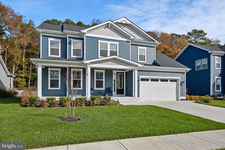 Welcome to 35134 Water Lily Court, a beautifully maintained and tastefully furnished home in the prestigious community of The Estuary in Frankford, Delaware. This two-year-old residence is situated on a premium lot with a tree-lined backyard and generous space between neighbors, the setting provides a sense of privacy and tranquility that’s hard to find.  Inside, thoughtful design upgrades and custom touches elevate every room. Ship lap accent walls add warmth and coastal charm in the office, powder room, front hallway, primary bathroom, loft, upstairs hallways, and bedrooms. The stairway has been enhanced with elegant wrought iron balusters. Throughout the home, Silhouette blinds filter the light beautifully while offering privacy, and builder-grade mirrors have been replaced with upgraded framed designs for a polished, refined look.  The kitchen is a showpiece, designed for both everyday living and entertaining. It features double wall ovens, a five-burner gas cooktop, and white trimmed, soft-close cabinetry topped with elegant crown molding. The expansive island comfortably seats six, perfect for casual meals or gathering with friends. A classic glass subway tile backsplash and pantry for storage complete this bright and functional culinary space.  The adjacent dining area provides easy access to the screened porch with a gas burning fireplace.    The living room is a true centerpiece, reimagined with a custom electric fireplace surrounded by white quartz stone veneer, floating tempered glass shelves with glass-tile backing, and built-in cabinetry topped with underlit quartz countertops that match the kitchen for a cohesive design flow. A custom driftwood mantel completes this inviting space.  Retreat to the primary suite, where a tray ceiling adds architectural interest and the generous walk-in closet where the primary closet now features tile flooring that seamlessly matches the adjoining bathroom. The spa-inspired bathroom offers a dual sink vanity, private water closet, and a frameless glass shower featuring dual shower heads and bench seating, all complemented by tile finishes and thoughtful design details.  The laundry room offers practical luxury with added cabinets, quartz countertops, an upgraded sink and faucet, and open shelving. The garage has been completely transformed with custom cabinetry, an epoxy-coated floor, fresh paint, and a convenient built-in bench with storage.  Ascend to the upper level, where an inviting family room awaits, accompanied by three additional bedrooms. One features a private ensuite bath, while a full hall bath serves the remaining rooms, ensuring comfort and privacy for both family members and guests.  Additional thoughtful details include custom mango wood cabinets in all bathrooms, upgraded fans in every room and the screened porch, enhanced irrigation with smart sensors, and dimmer switches throughout for tailored lighting control.  This sought-after coastal community offers a true resort-style living experience surrounded by natural beauty and abundant recreation. Residents enjoy an outdoor pool with sun deck, clubhouse with fitness center and billiards, and welcoming gathering spaces. Active living thrives with tennis and pickleball courts, walking and jogging trails, bocce, a putting green, and a dog park with separate areas for small and large dogs. A fishing pond across the street is stocked with big bass, and the HOA provides lawn care, snow removal, and a seasonal beach shuttle. Nearby, the Assawoman Wildlife Area offers boat launches, hiking, biking, and wildlife observation. Blending resort amenities with preserved landscapes, The Estuary delivers a rare balance of relaxation, recreation, and connection to nature.