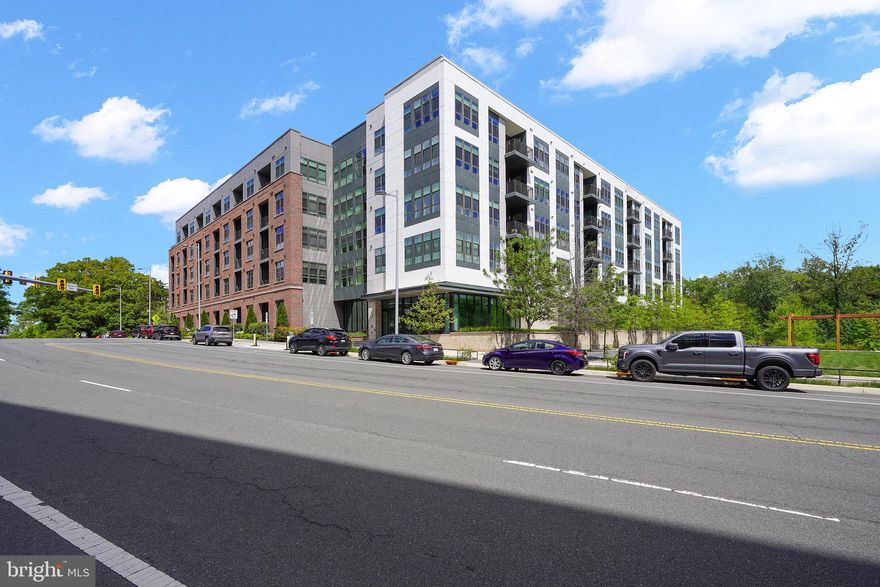 Welcome to The Bexley, Tysons' premier luxury condominium community, where sophisticated design meets effortless everyday living. This beautifully appointed residence offers an open-concept layout with soaring 10-foot ceilings, wide-plank LVP floors, and expansive windows that flood the home with natural light. The chef's kitchen is appointed with quartz countertops, a large center island, modern cabinetry, and premium stainless-steel appliances — ideal for both casual mornings and elevated entertaining. The spacious primary suite offers a private retreat with an over-sized shower and generous walk-in closet with built-in cabenitry, while the additional bedroom provides flexibility for guests, or a media room.  The den functions as an office or guest room.  Step outside onto your private balcony and enjoy the serene, tree-lined backdrop that makes this home feel like a world apart — yet you're under a mile to the McLean Metro and minutes from Tysons Galleria, Capital One Hall, Whole Foods, and an abundance of dining and shopping. Two garage parking spaces convey along with a storage unit. Residents of The Bexley enjoy upscale amenities including a modern fitness center, resident lounge, concierge service, outdoor grill area and pet-friendly spaces. This is refined, low-maintenance living at its finest.  Seeing is believing!