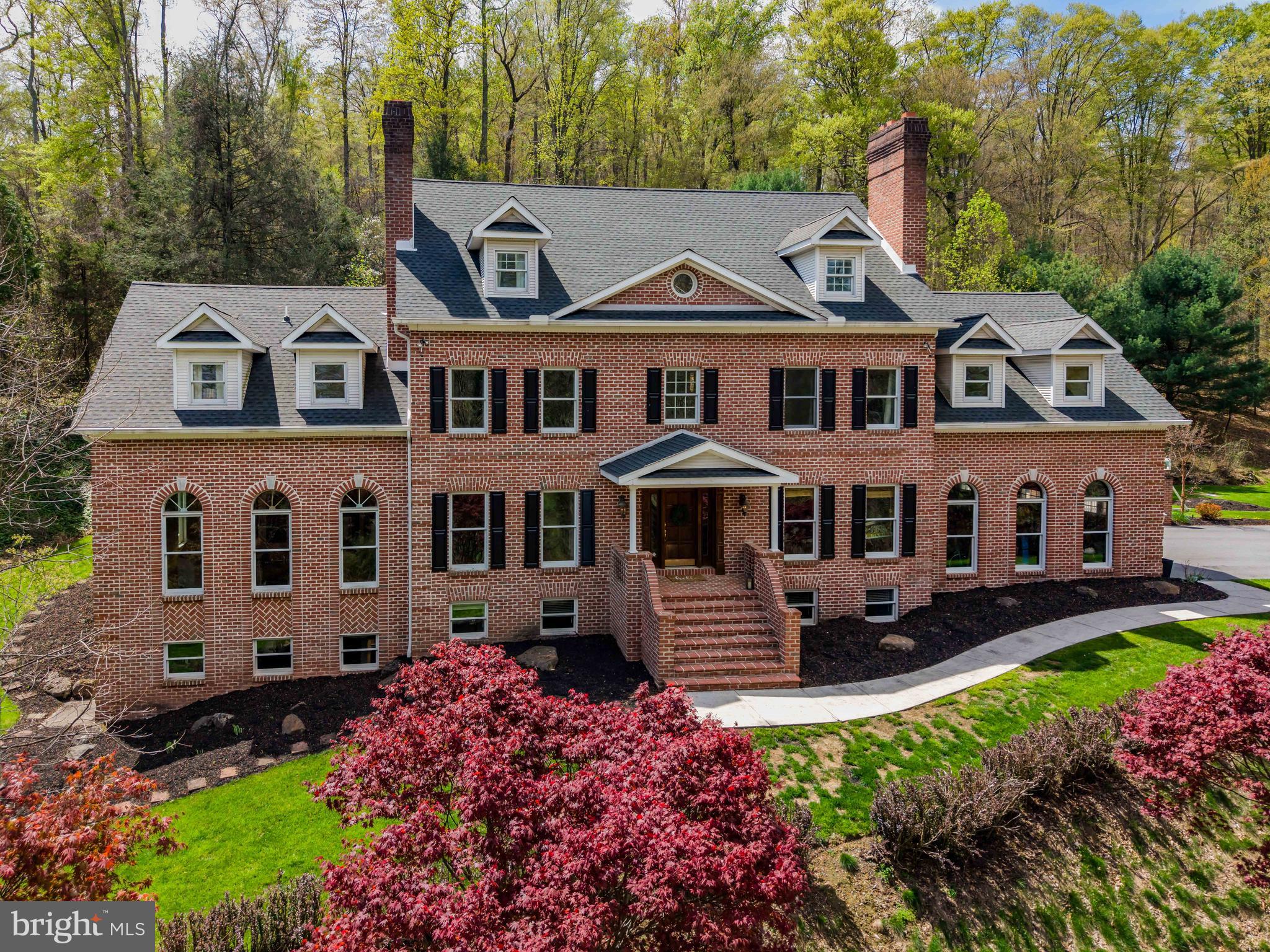 **Welcome to Your Private Paradise on Over 18 Acres!**
An extraordinary opportunity to own your very own private oasis awaits! This sprawling estate features more than 18 acres of natural beauty, including over 400 feet of Yellow Breeches Creek frontage, a rolling meadow with a stream and pond, and acres of wooded land - perfect for enjoying serene nature right in your own backyard.
At the heart of the property stands a stately brick Colonial offering more than 7,000 square feet of living space. Designed with craftsmanship in mind, the home boasts custom woodwork, crown molding, transom windows, French doors, hardwood floors, and four fireplaces - a timeless blend of elegance and warmth. Main Floor: Made for Entertaining - Gourmet kitchen with copper farmhouse sink, stainless steel appliances, central island & peninsula, eat-in area, and ample cabinetry… seamless flow into the formal dining room, perfect for gatherings. Sunken living room with large windows and a floor-to-ceiling brick fireplace. Lodge-inspired 4-seasons room featuring radiant heated floors, bar area, and stone fireplace, opening to your outdoor entertaining space. Covered outdoor living area with kitchen (Lynx appliances, granite counters, overhang seating), paver patio, and heated inground pool. Powder room with pool access, office with marble fireplace, and spacious laundry room complete the first floor. Second Floor: Your Private Retreat -Owner’s suite with sitting area and marble fireplace, spa-like en-suite with double vanities, jetted tub, rainforest shower, and large walk-in closet. Three additional bedrooms (one with a private bath), plus another full bath complete the second floor. Third Floor & Lower Level: Flexible Living - Finished third floor with open living space, bedroom, and bathroom. Full lower level offers two more bedrooms, full bath, and plenty of unfinished space for storage or future projects. Additional Features: attached 3-car garage, spacious 40'x80' pole barn, currently used as a dynamic sports training facility, equipped with netting for two batting cages and even includes a basketball court! Whether you're looking to keep the space as-is or transform it to suit your needs, the options are wide open — from an indoor pickleball court to car storage or a custom hobby workshop.
Enjoy total privacy without sacrificing convenience of amenities and access to major highways. Whether you’re looking for a peaceful retreat, a stunning venue for entertaining, or a home base for outdoor adventure, this exceptional estate offers luxurious living with a backdrop of natural beauty.