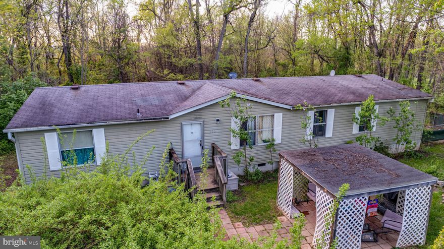 Motivated seller, bring ALL OFFERS! 2 Acres and no HOA. Specious doublewide on a permanent foundation. Front yard complete with an arbor to enjoy your favorite beverage on a beautiful day! Step inside to the spacious living and dining room combo. To the right you'll find the primary bedroom complete with a walk-in closet. Primary bath boasts a large soaking tub and a separate shower. Open kitchen has a center island with a built-in gas cook top. Second dining area is spacious enough to accommodate a large dining room table that leads to the sliding glass doors and fenced in back yard. $5,000 allowance toward closing expenses.