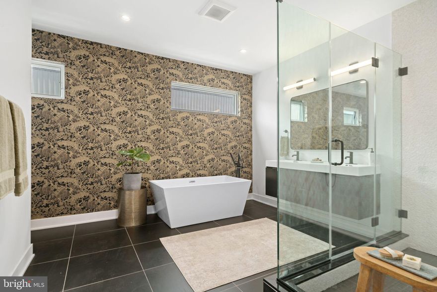 FINAL PHASE NEW CONSTRUCTION, FULL 10 YEAR TAX ABATEMENT!!! Luxury townhome with 2-car garage parking on the brand new League Court, a beautiful pedestrian-only green space!  This extra wide modern townhome at the former site of the Frankford Chocolate Factory presents a unique urban experience in close proximity to Center City, major transportation routes, universities, and hospitals. Boasting 3,200 total square feet of space, custom designed finish selections, and unmatched center city views. Go up the front steps into the expansive living room with 15 foot high ceiling and an open floor plan concept that leads you into the dining and kitchen area. The  ample dining area features a convenient half bathroom and flows into the gourmet chef designed kitchen. The kitchen features an oversized center island, quartz countertops, tile backsplash, stainless steel Cafe appliances that include drawer microwave, cooktop, double oven, and range hood. Exit the back of the kitchen to the rear deck that extends 8 feet off the rear wall: perfect for entertaining guests, outdoor grilling, and dining under the stars! Upstairs you will find two large bedrooms with large closets and a shared full bathroom. This floor is also equipped with a laundry room with gas washer and dryer and cabinets for storage. Continue to the top floor and enter the master bedroom suite with gorgeous center city views through the North facing windows. Continue down the hallway from the master bedroom to the walk-in closet that was meticulously designed to maximize space and efficiency. The master bath is wrapped in floor to ceiling tile and features a freestanding soaking tub, oversized shower room of seamless glass, a private lavatory, a double vanity, heated floors, and designer plumbing fixtures. Before you exit to the roof deck, there is a wet bar and sink conveniently located to entertain your guests as well as a half bathroom.  The roof deck is complete with green roof finishes and features spectacular panoramic views of the Philadelphia skyline. Special attention has been given to the rooftop design to maximize the usable space while enjoying the benefits of having a green roof. There is additional living space in the finished basement. Perfect for use as an office, workout/fitness room, or additional sitting area. If those features aren't enough, pull into the private paver driveway of this development and into your two car garage. These homes have a Ring camera system and have dual-zoned energy-efficient HVAC systems with NEST thermostats. metal handrails, recessed lighting throughout, and PELLA windows. Walk Score - 97, Transit Score - 100, Bike Score - 88. Conveniently located near Target, Sprouts Market, Whole Foods, Pet Smart, and on site CVS and Aldi on the way. 10 Year Tax Abatement. Taxes are estimated. Finishes shown in photos are of model home and may change or vary based on availability and builders discretion. Photos are of model home. Buyer has the ability to select some finishes. Fall Deliveries Available