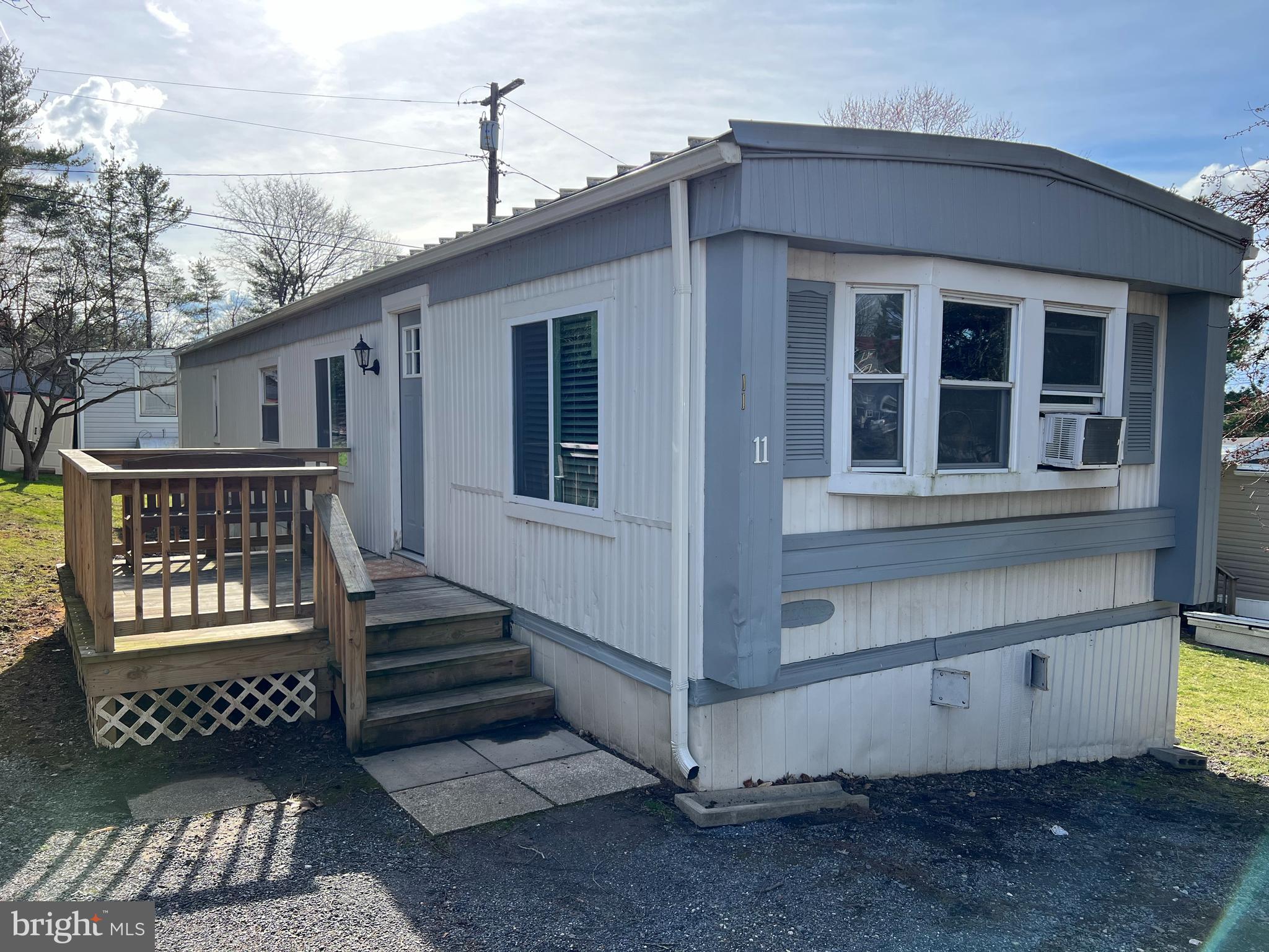 Welcome home to this RARE and adorable 2 Bedroom and 1 Full Bath Mobile Home on Lot #11 in the Taylorsville Mobile Home Community in Mount Airy! You are greeted with a front porch deck where you can enjoy a quiet atmosphere with no neighbors to this side. The home has a nice open concept with laminate plank flooring. The recently updated Kitchen features granite countertops and white cabinets with plenty of storage, an electric cooktop range, built in microwave, dishwasher, an extra deep freezer, and a bay window. The Living and Dining Areas are open and inviting. Both Bedrooms have been updated with Brand New Carpet! The Full Bathroom has an oversized stall shower and the Laundry Room has a full sized washer & dryer set. Brand New Heating Furnace and updated energy star vinyl dual glazed sliding windows in the home are sure to help save you money for years to come. Two storage sheds are included and you have two convenient parking spaces out front. Taylorsville Community has a Lot Rent and currently it is $625/month. The monthly Lot Rent includes community well water, sewer, trash & garbage removal, maintenance of the roads & common areas, and use of the common facilities. There is a simple approval process with an Application with the Park Managers. Should you wish to move the home to a different location - you must go through the process with the park managers. Mobile homes in Mount Airy do not come on often and this is a rare opportunity.