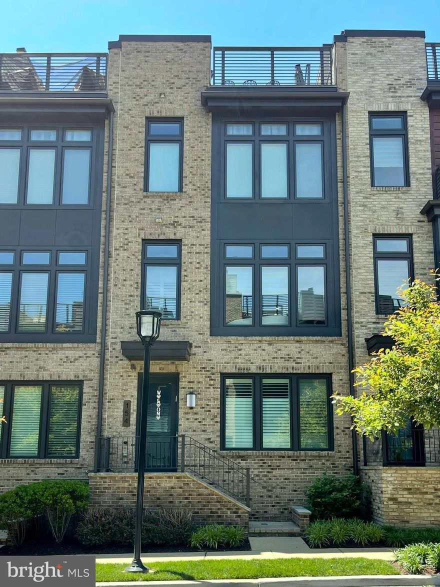 Modern Elegance Meets Thoughtful Upgrades at 154 Winsome Circle

Step into sophistication at this Grosvenor Heights elevator townhome, where over $130K in curated upgrades elevate every corner of this contemporary residence. Designed with both comfort and functionality in mind, this home showcases standout features you won’t find in any standard Everett model.

The heart of the home is a sleek, open-concept kitchen outfitted with top-tier Thermador, Bosch, and Sub-Zero appliances, a stylish quartz island, extended stacked cabinetry to the ceiling, and a herringbone glass tile backsplash—all grounded by stunning Oceanside Gray hardwoods that continue through the main living areas and upper levels.

A great room gas fireplace adds warmth and ambiance, while enhanced LED recessed lighting throughout provides a clean, modern glow in every space. Oak stairs and upgraded steel interior stair rails offer an architectural edge, complemented by hardwoods that run throughout all levels of the home.

The luxurious owner’s bath includes a frameless glass shower, niche shelving, and upgraded quartz counters, plus richly tiled walls and floors for a spa-like experience. The multi-gen suite, powder room, and laundry space were also thoughtfully finished with coordinated tile and fixtures.

Enjoy effortless entertaining on the roof terrace, complete with porcelain pavers, a built-in kitchen with granite surround, and wired for a retractable awning, and views from one of the best spots in the community. The rear deck includes a gas line with quick-connect for flexible outdoor living.

Tucked in a premier Bethesda location with easy access to downtown and top-rated schools, this townhome is the perfect blend of style, substance, and smart upgrades.