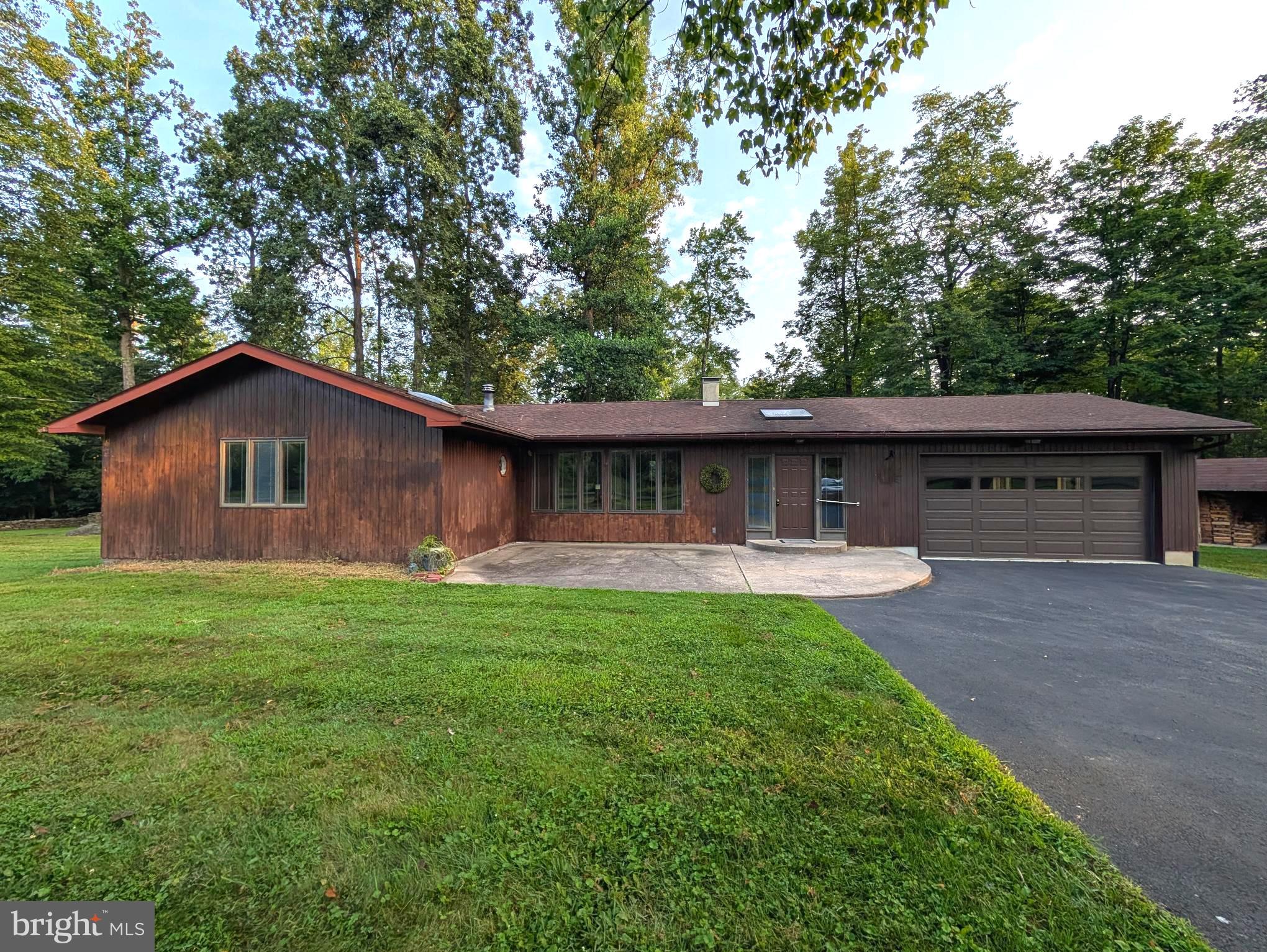 Enjoy all the peace and serenity Tinucim Township has to offer!! Opportunities like this don't come around often. This charming ranch-style home offers a perfect blend of comfort and tranquility. The property exudes a warm, inviting atmosphere that makes it feel like home from the moment you step inside. This spacious residence features three bedrooms and two full bathrooms, providing ample space for relaxation and privacy. The heart of the home is the expansive living area, perfect for gathering with friends and loved ones. Step outside onto the inviting deck, where you can enjoy peaceful views of the surrounding trees and woods, creating a perfect backdrop for morning coffee and evening sunsets. Parking is a breeze with a large garage that accommodates two vehicles, along with additional driveway space for guests. The oversized garage also provides extra storage, ensuring you have room for all your outdoor gear. This property is not just a house; it's a retreat from the hustle and bustle of everyday life. With its lush surroundings and spacious layout, it invites you to create lasting memories. Experience the joy of living in a home that offers both comfort and a connection to nature. Don't miss the opportunity to make this delightful property your own!