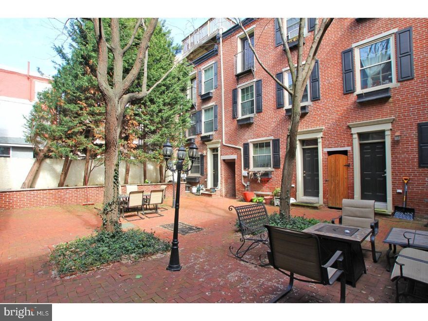 This charming townhouse in an ideal NoLibs location has both shared and private outdoor spaces. Accessed through a pretty communal courtyard, the home has all the benefits of a city location but is set back from the noise of the street. You are welcomed into the main level by lovely original hardwood floors, wainscoting and crown molding throughout the living and dining areas. At the rear is the L-shaped kitchen with granite countertops, crisp white cabinets, double-basin undermount sink and access to the rear deck. There are storage solutions galore in the form of a large coat closet, bonus corner pantry and finished basement with huge storage closet complete with built-in shelves, a laundry area and a separate space perfect for a home office, media or yoga room. The noteworthy closet space continues on the second floor with two good-sized bedrooms, one with built-in shelving alongside a full-wall mirrored armoire, and the other with a more traditional double-wide reach-in closet. There's a nicely appointed hall bath with cool black marble floors and contrasting bright white vanity. The master suite takes up the entire third floor and features an enormous wall-to-wall built-in closet and dressing area, Juliet balcony and en-suite bath with extra-wide walk-in steam shower with travertine tile surround. Convenient to the Girard Ave trolley and the 2nd St St strip, this home is also within blocks of community greenspace at Liberty Lands Park as well as neighborhood gems like Bardot Cafe, Honey's Sit-N-Eat and Cafe La Maude.